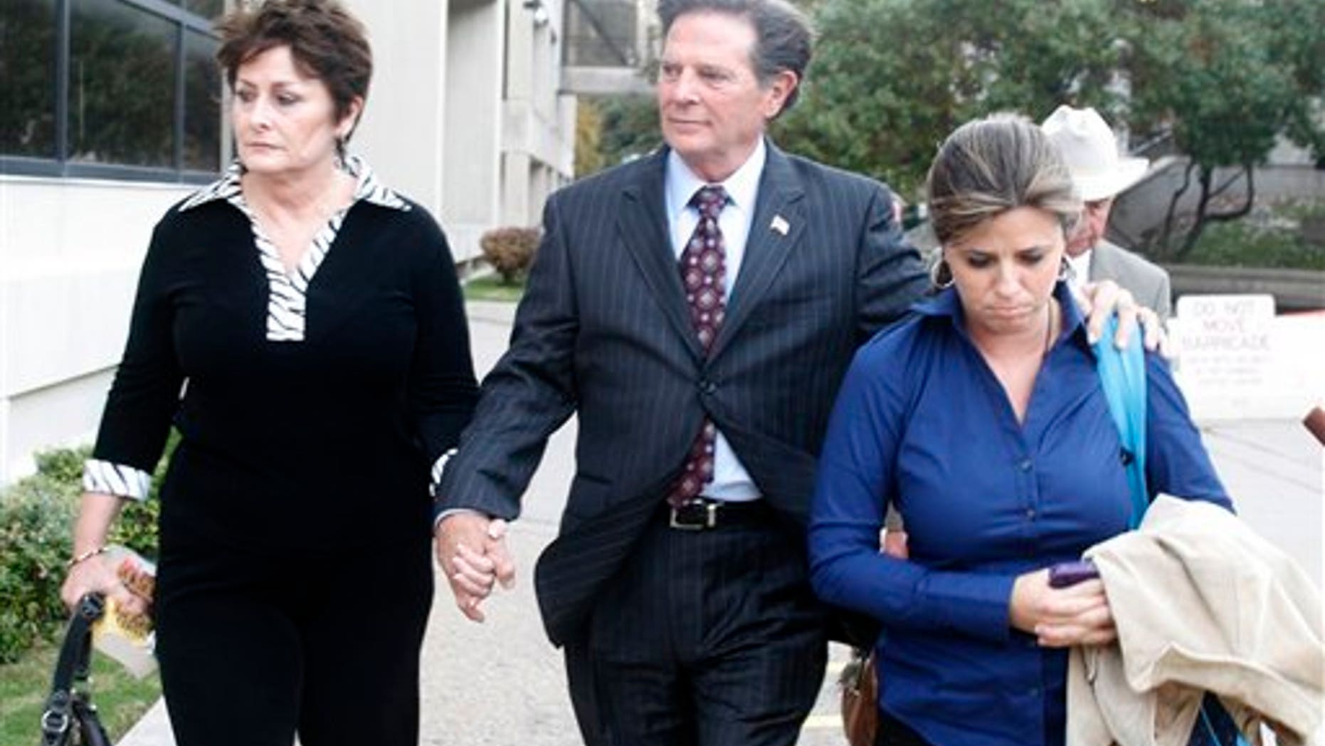 Former House Majority Leader Tom DeLay, along with his wife Christine and daughter Danielle Garcia, leave the Travis Coumty Courthouse in Austin, Texas on Wednesday, Nov. 24, 2010. A jury found Delay guilty of money laundering and conspiracy to commit money laundering. (AP Photo/Jack Plunkett)