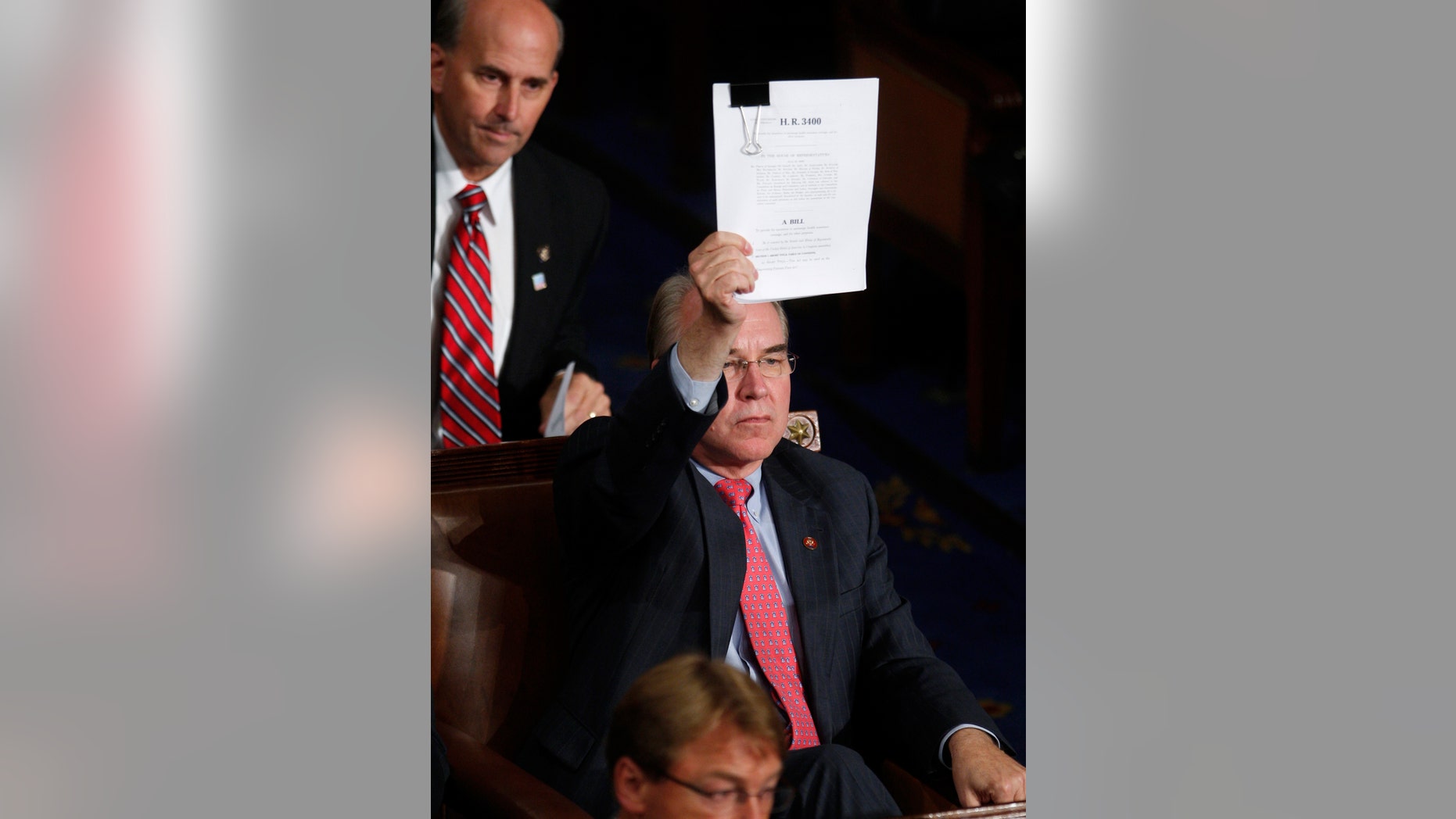 FILE: Sept. 9, 2009: Rep. Tom Price, R-Ga., holds up the Republican version of the health care bill on Capitol Hill in Washington.