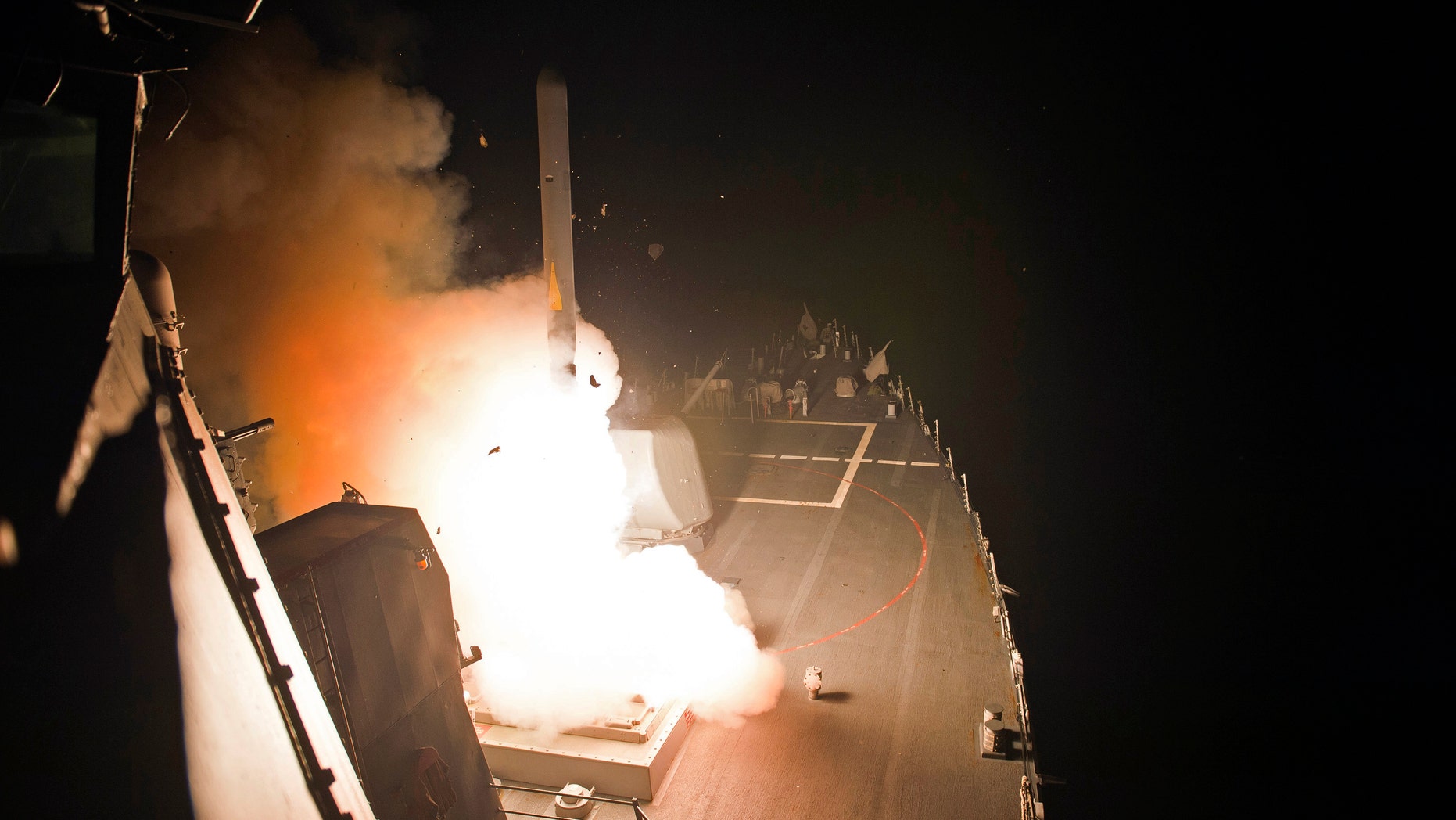 In this photo released by the U.S. Navy, the guided-missile destroyer USS Arleigh Burke launches Tomahawk cruise missiles, in the Arabian Gulf, Tuesday, Sept. 23, 2014.