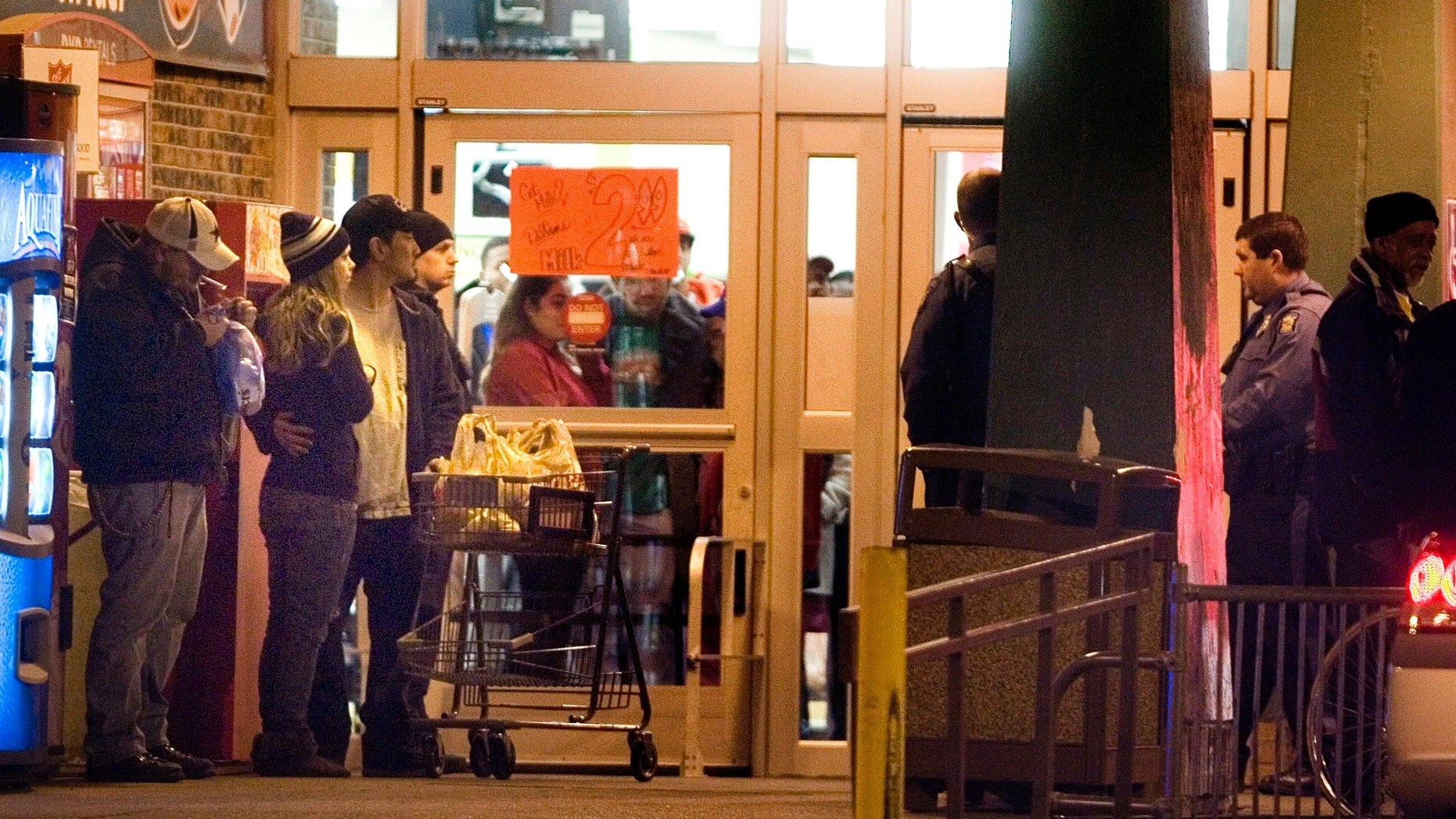 Dec. 16, 2012: Bystanders watch as Topeka police investigate at the scene of a shooting outside a grocery store in Topeka, Kan.
