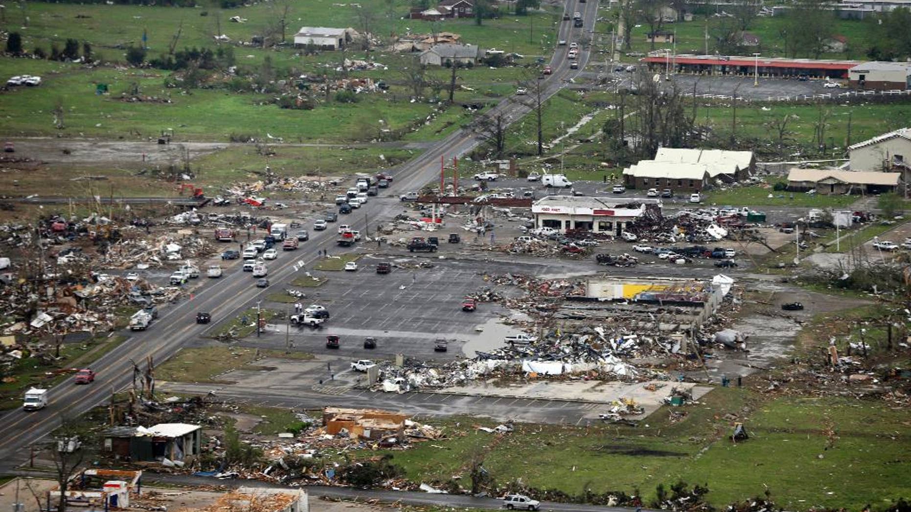 FILE - This Monday, April 28, 2014 aerial photo shows destroyed buildings and debris along U.S. Highway 64 in Vilonia, Ark. Vilonia was hit hard Sunday for the second time in three years. Four people were killed in a 2011 storm. Until this late April 2014 outbreak, the U.S. as a whole had by far the quietest start of the year for tornadoes. Longer trends show more tornado clusters recently. (AP Photo/Danny Johnston)