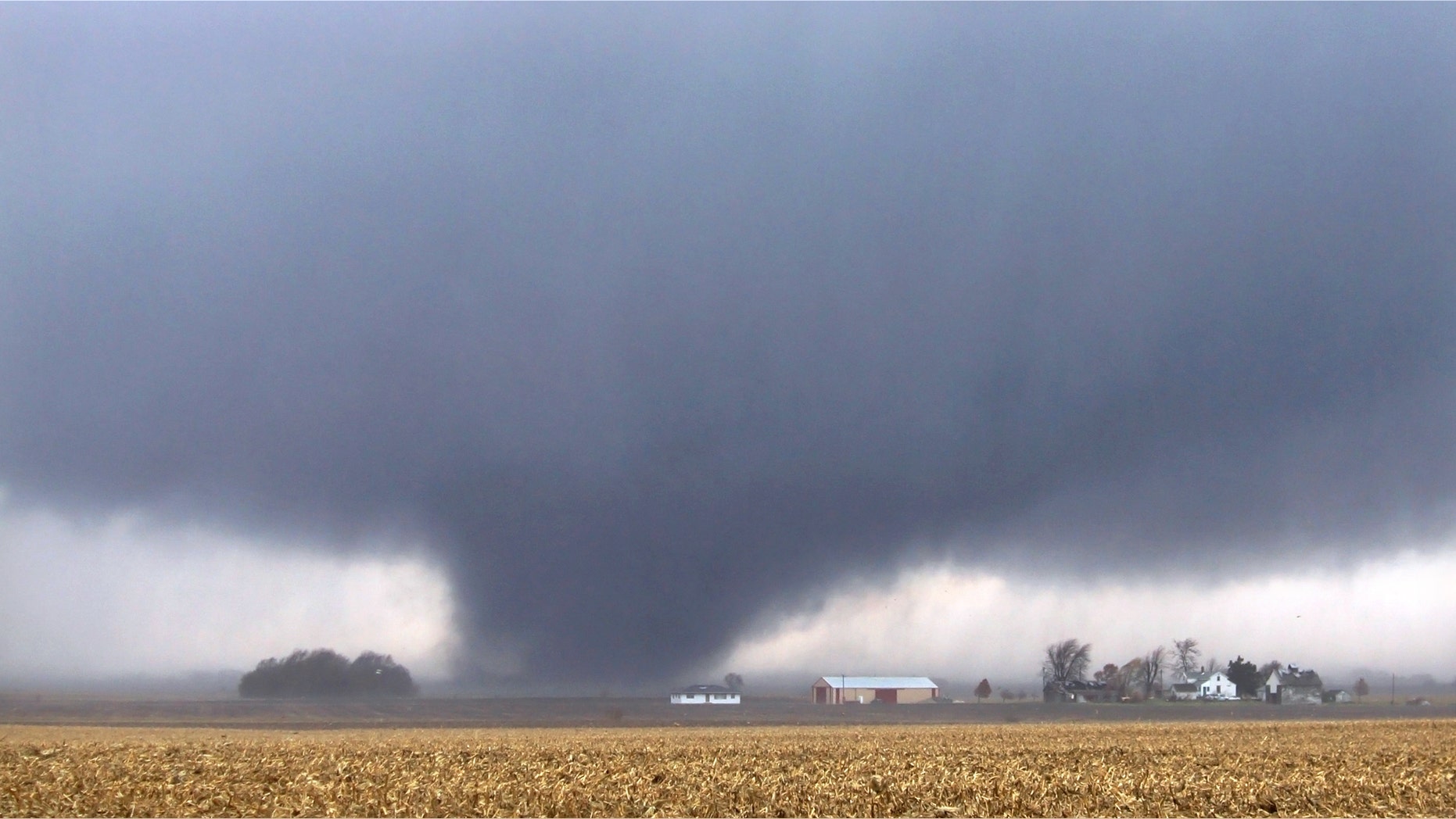 A tornado moves northeast Sunday, Nov. 17, 2013, two miles west of Flatville, Ill. The tornado damaged many farm buildings and homes on its way to Gifford, Ill., where scores of houses were devastated. (AP Photo/News-Gazette, Jessie Starkey) MANDATORY CREDIT
