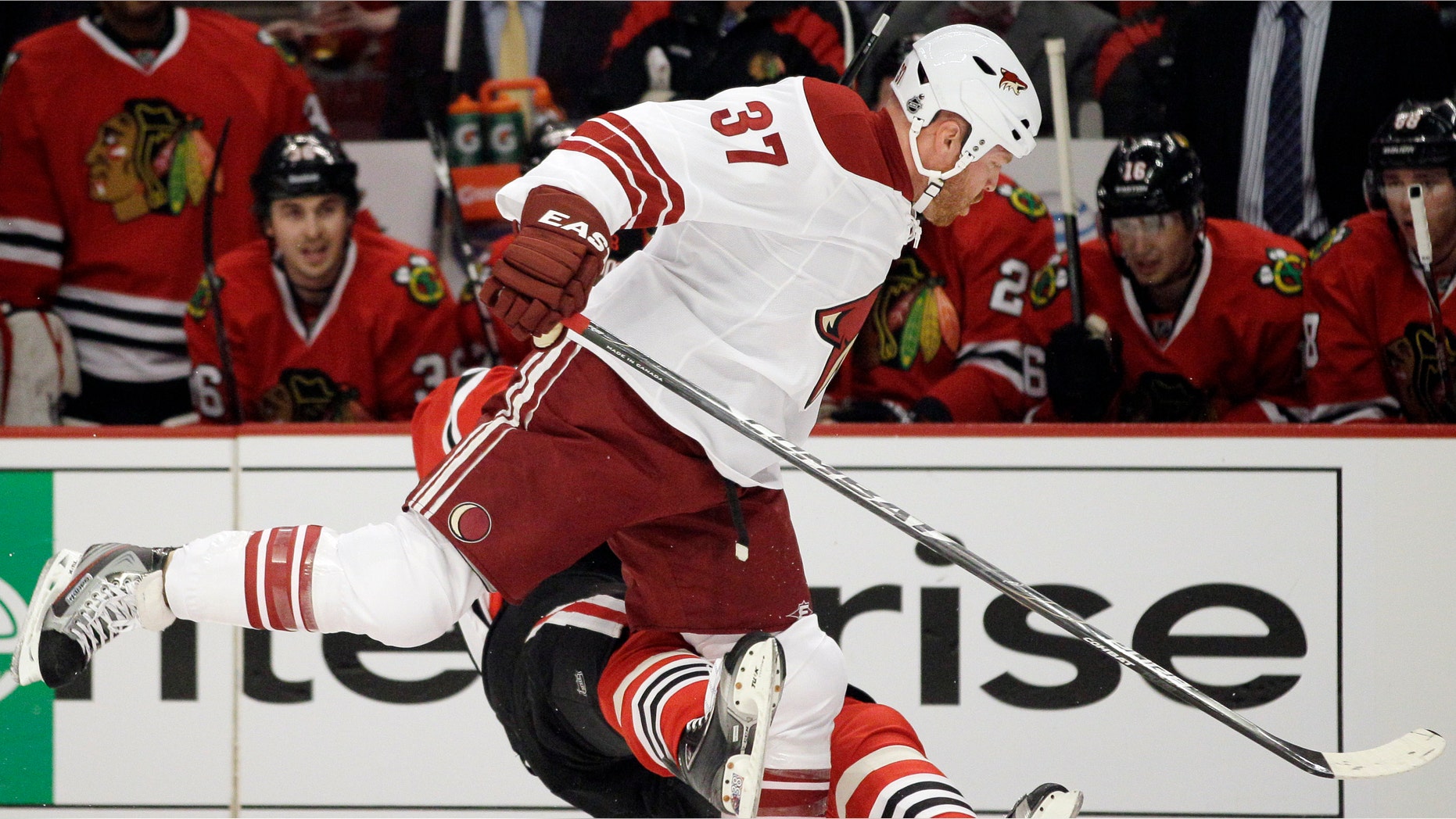 Chicago Blackhawks' Marian Hossa (81) of Slovakia, falls down after taking a hit from Phoenix Coyotes' Raffi Torres (37) during the first period of Game 3 of an NHL hockey Stanley Cup first-round playoff series in Chicago, Tuesday, April 17, 2012. (AP Photo/Nam Y. Huh)