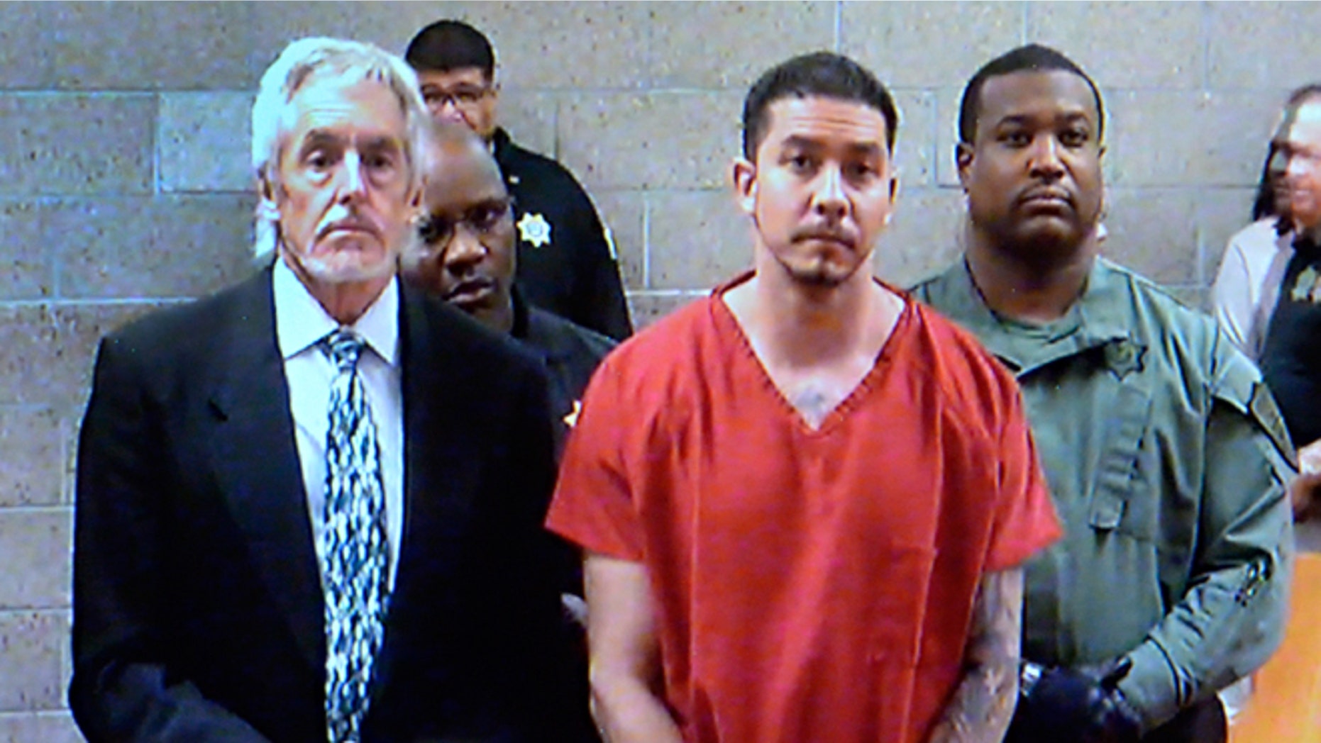 In this video frame grab provided by the Albuquerque Metro Court, Tony Torrez, center, stands with public defender Jeff Rein, left, while making an appearance at the Albuquerque Metro Court via video in Albuquerque, N.M., Thursday, Oct. 22, 2015. Torrez has been charged with murder, assault, child abuse and other crimes following his arrest Wednesday in a deadly road rage shooting that killed a 4-year-old girl. (Albuquerque Metro Court/The Albuquerque Journal via AP, Pool)