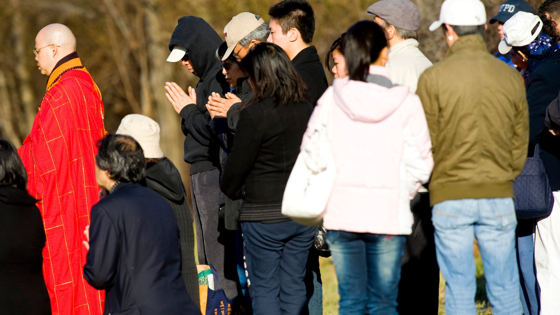 Victim's family members participate in a Buddhist service at the location of a tour bus crash that left fifteen people dead, Saturday, March 19, 2011 in the Bronx borough of New York. Fifteen people were killed March 12, when the bus returning to New York from Connecticut overturned and was split in two by a sign support pole.
