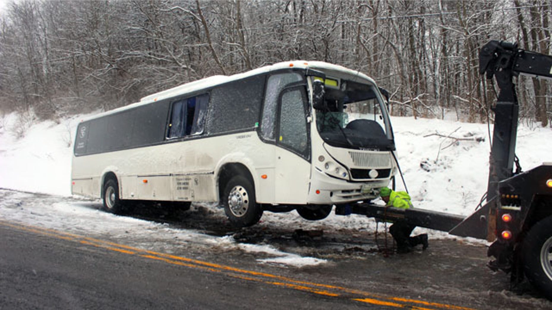February 9, 2014: An Interstate Emergency Services employee hooks up a bus to a tow truck to pull it out of the ditch on Route 220 in Cumberland Valley Twp., Pa. (AP Photo/Bedford Gazette, Bridgett Weaver)