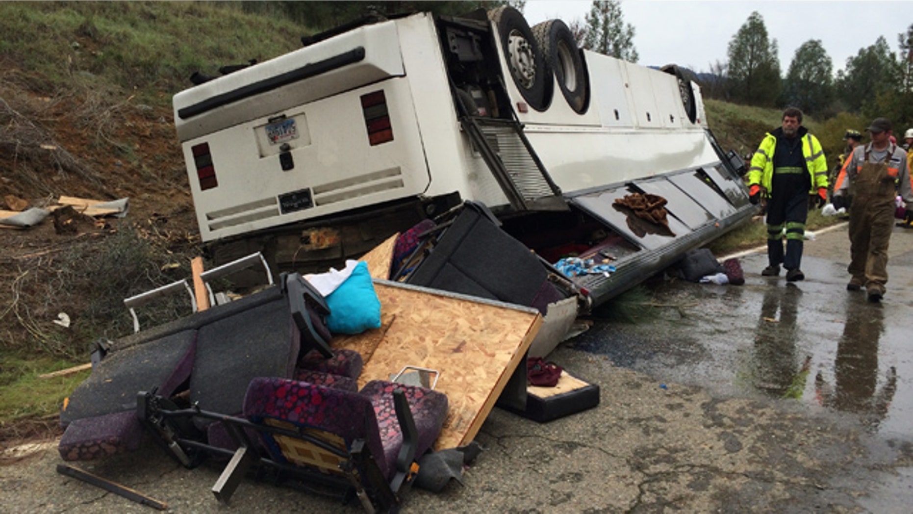 November 23, 2014: Emergency personnel check a tour bus that had already crashed earlier in the day and overturned just off Interstate 5 in Northern California, killing one person and sending dozens to hospitals near the Pollard Flat area in Redding, Calif. (AP Photo/The Record Searchlight, Alayna Shulman)