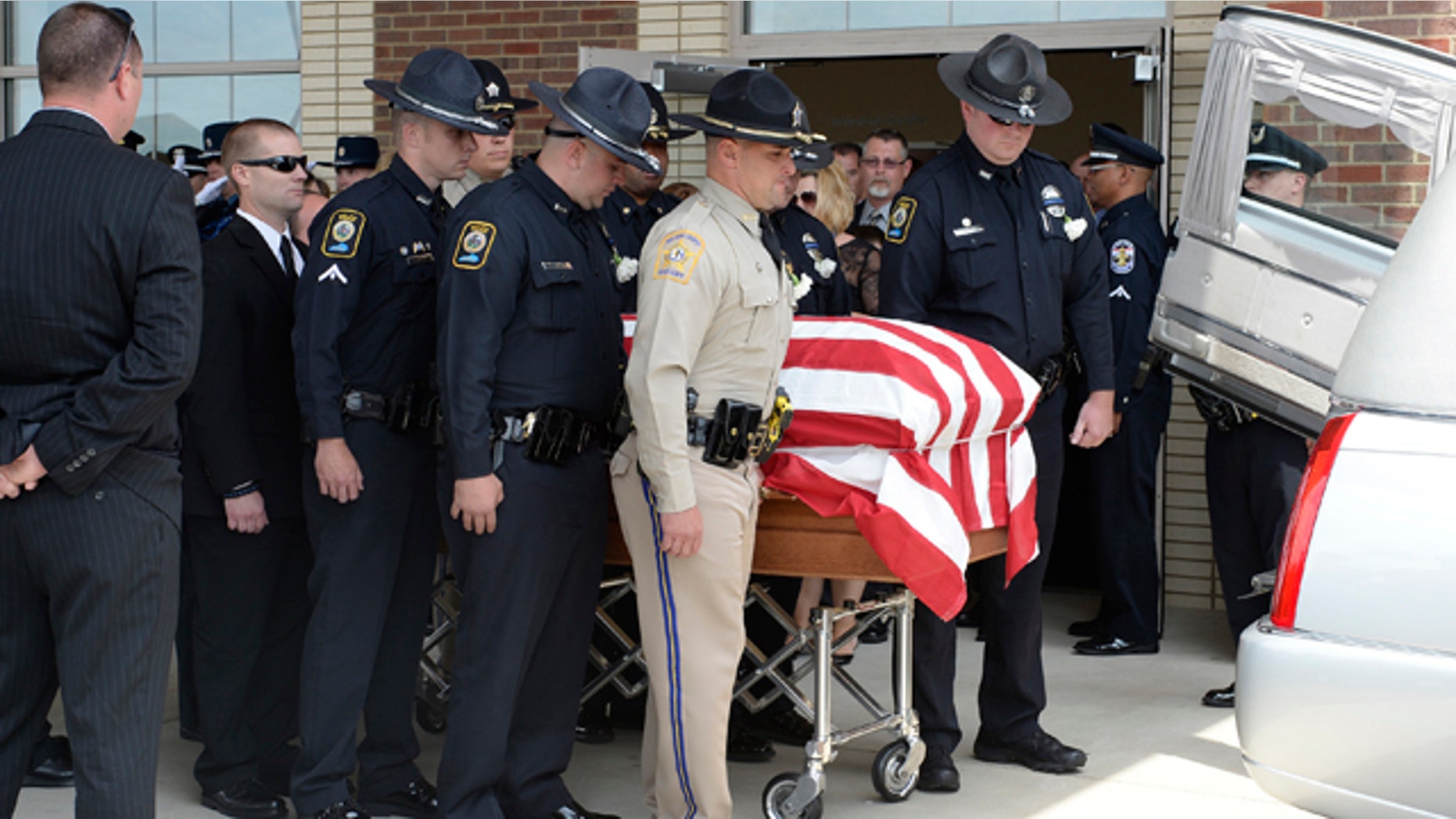 May 30, 2013: The body of fallen Bardstown police officer Jason Ellis, who was killed in an ambush slaying on May 25, 2013, is placed in a hearse during his funeral at the Parkway Baptist Church in Bardstown, Ky.