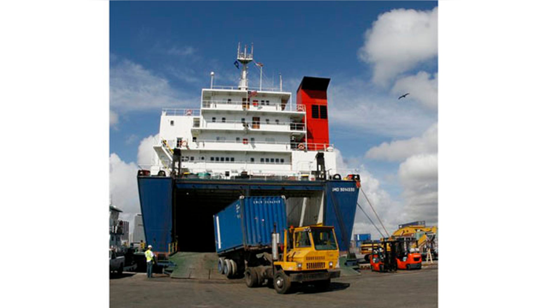 Feb. 4: A container is unloaded from the cargo vessel Seaboard Sun while docked at the Port of Miami in Florida. U.S. companies sold fewer products overseas in February but the trade deficit still narrowed because of a big decline in oil imports.