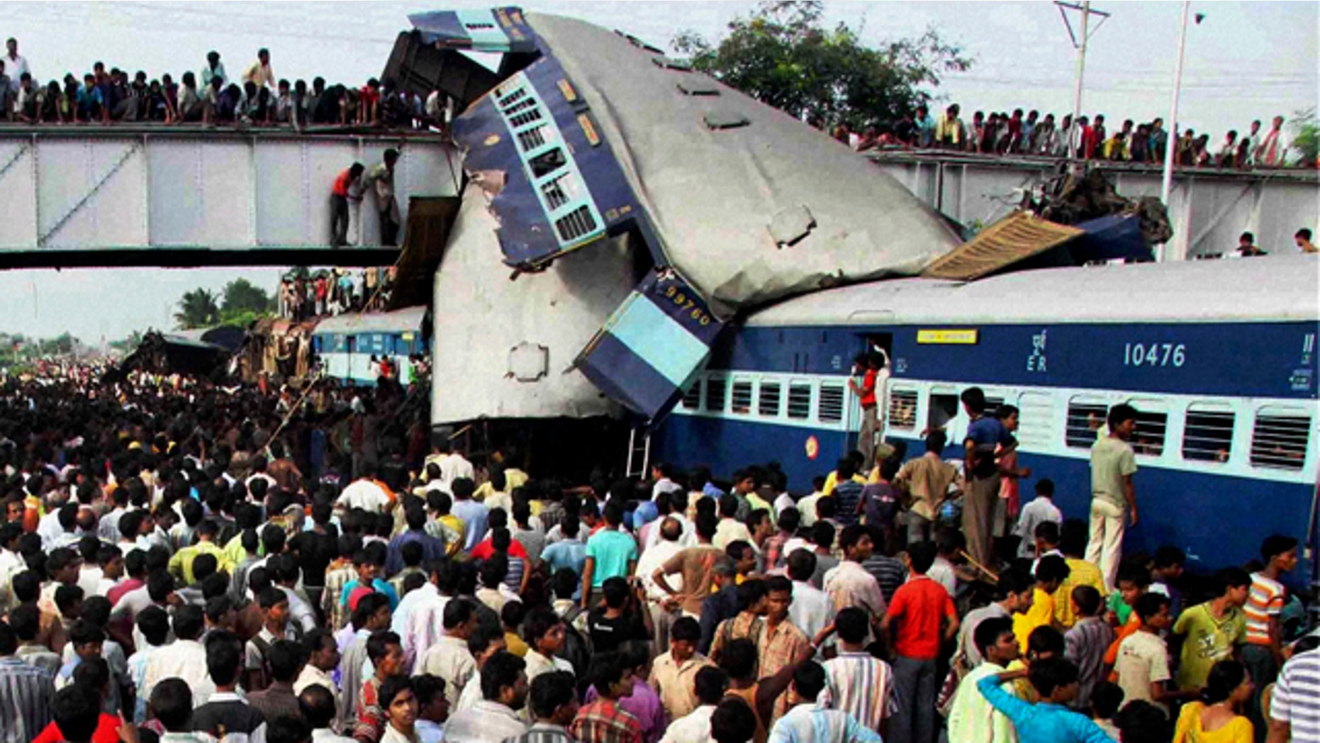 July 19: A speeding express train collided with a passenger train at the Sainthia station in eastern India early Monday, mangling the carriages and killing scores of people, railway police said. (AP)