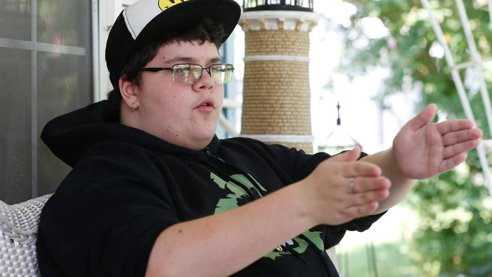 This Tuesday Aug. 25, 2015 photo shows Gavin Grimm as he gestures during an interview at his home in Gloucester, Va. Grimm is a transgender student whose demand to use the boys' restrooms has divided the community and prompted a lawsuit. (AP Photo/Steve Helber)