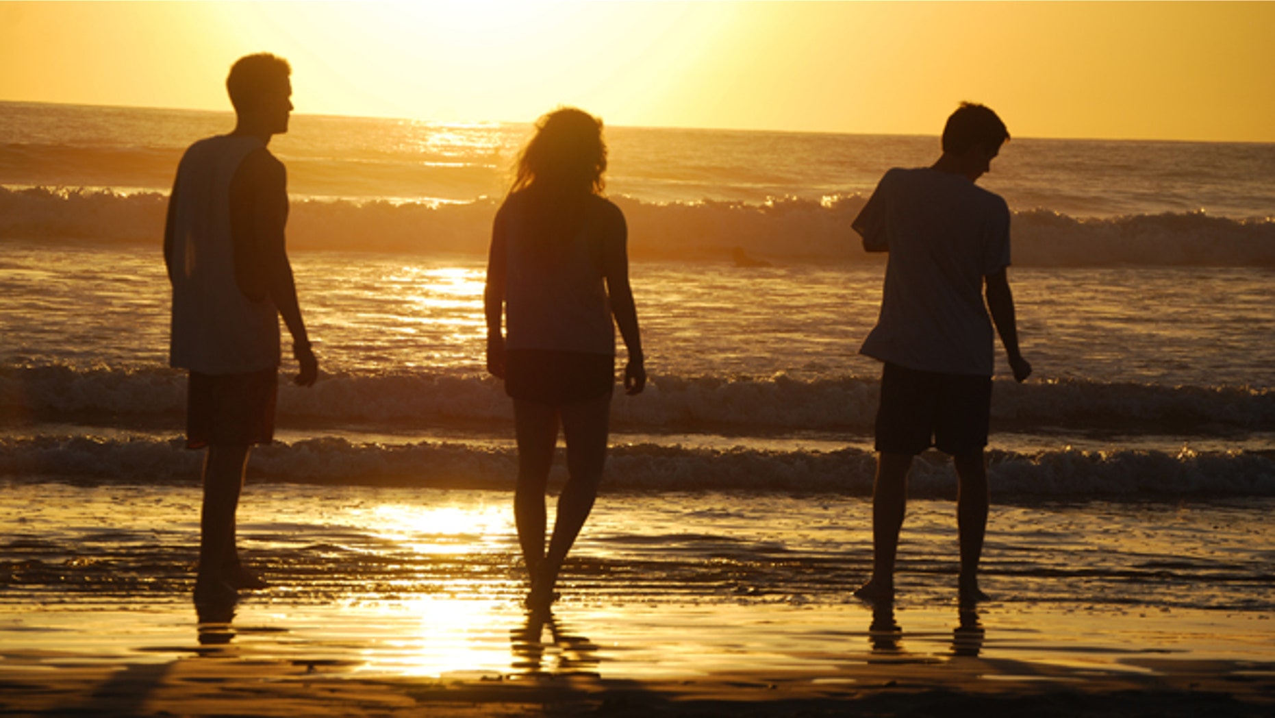 This February 2014 photo released by Kristina MacKulin shows, from left, Liam Godfrey-Jolicoeur, Ruby Dombek and Jacob Dombek of N. Ferrisburg Vt. watching the sunset at Playa Guiones in Nosara, Costa Rica. Nosara is a scenic coastal region with a variety of outdoor recreation activities for visitors. (AP Photo/Kristina MacKulin)