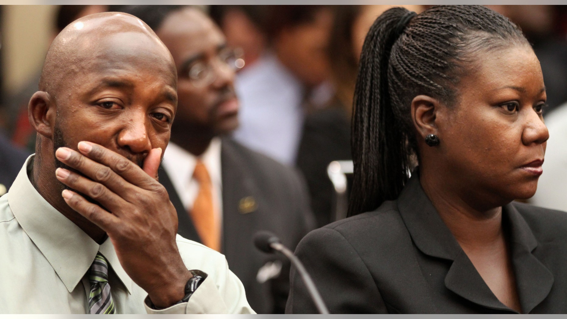 Trayvon Martin's parents, father, Tracy Martin, left, and mother Sybrina Fulton attend a House Judiciary Committee briefing on racial profiling and hate crimes, Tuesday, March 27, 2012, on Capitol Hill in Washington. (AP Photo/Jacquelyn Martin)