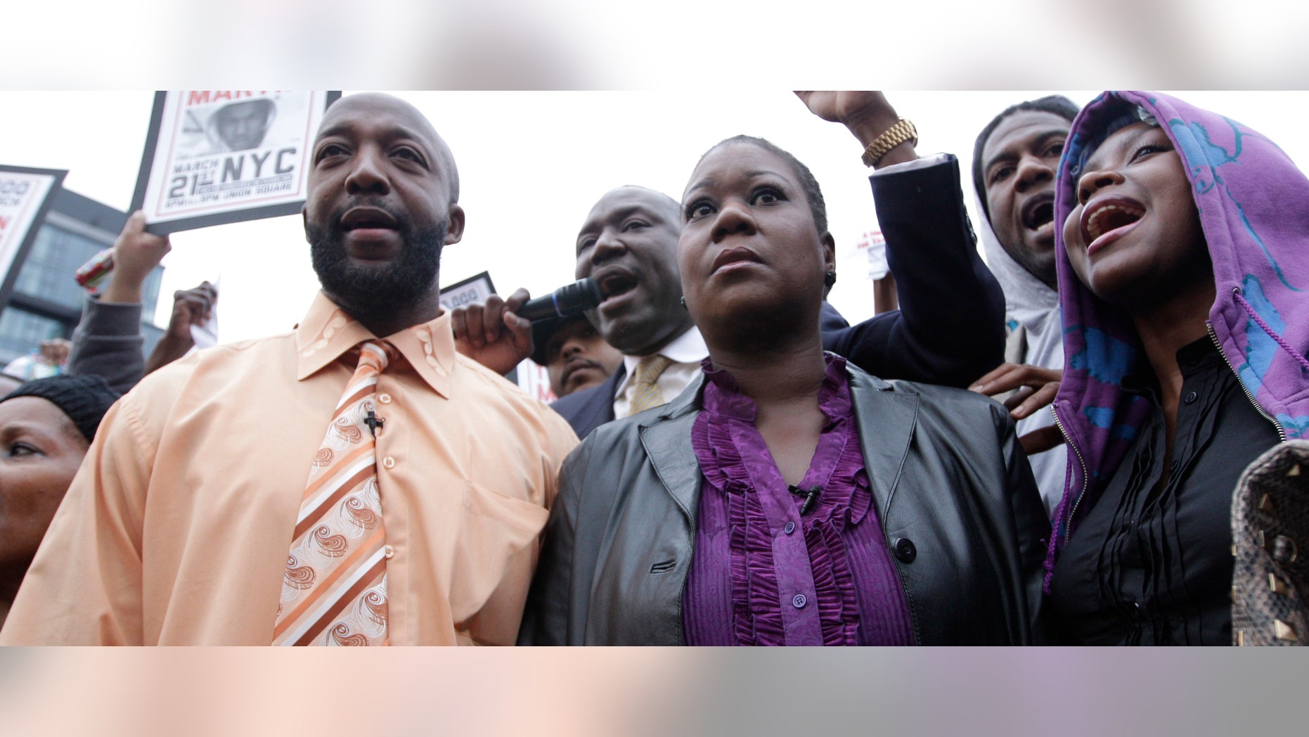 Trayvon Martin's parents Tracy Martin, left, and Sybrina Fulton, center, are joined by an unidentified woman during the Million Hoodie March in Union Square in March, 2012 in New York.