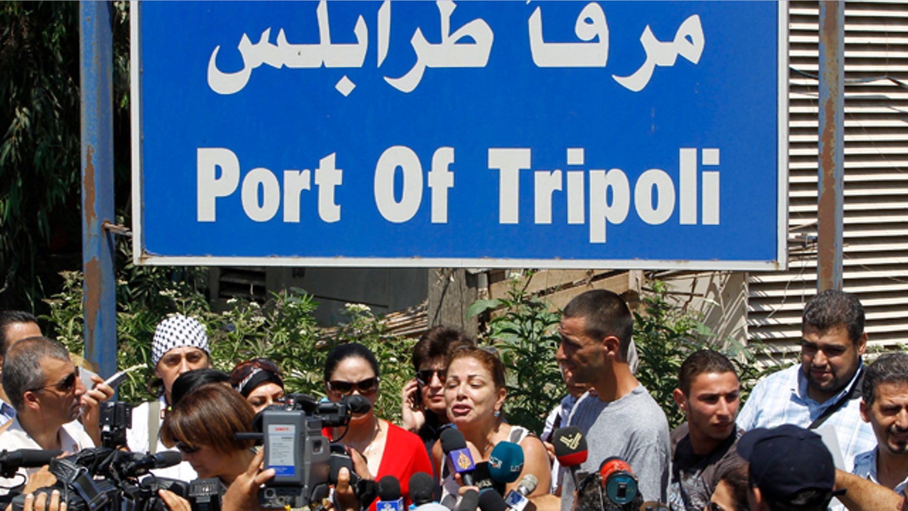 Aug. 19: Lebanese Samar al-Hajj, center, one of the organizers of Mariam ship that plans to sail to Gaza Strip, speaks during a press conference outside the seaport of Tripoli in Lebanon. (AP photo)