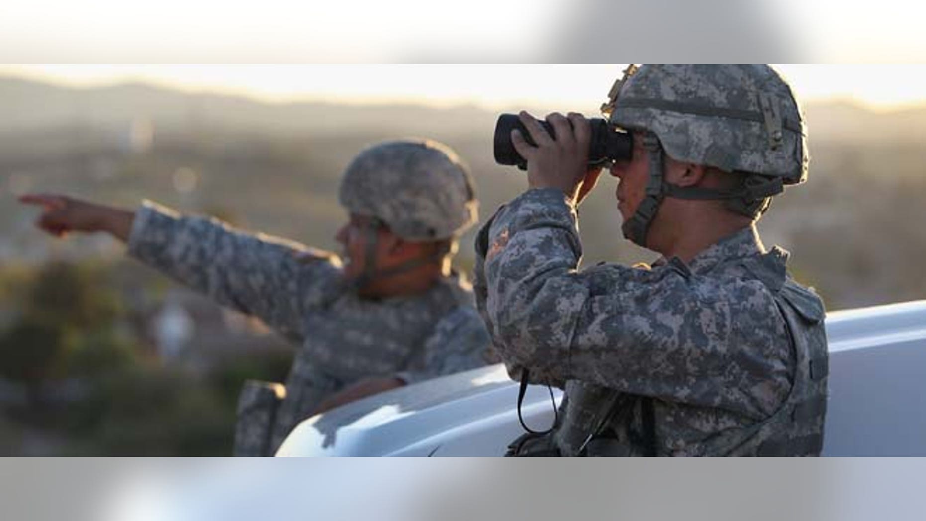 NOGALES, AZ - JUNE 22: U.S. Army National Guardsmen scan the U.S.-Mexico border on June 22, 2011 in Nogales, Arizona. The Obama administration will reduce the number of troops along the Mexican border, a spokesman for a Texas congressman said on Dec. 13, 2011. (Photo by John Moore/Getty Images)