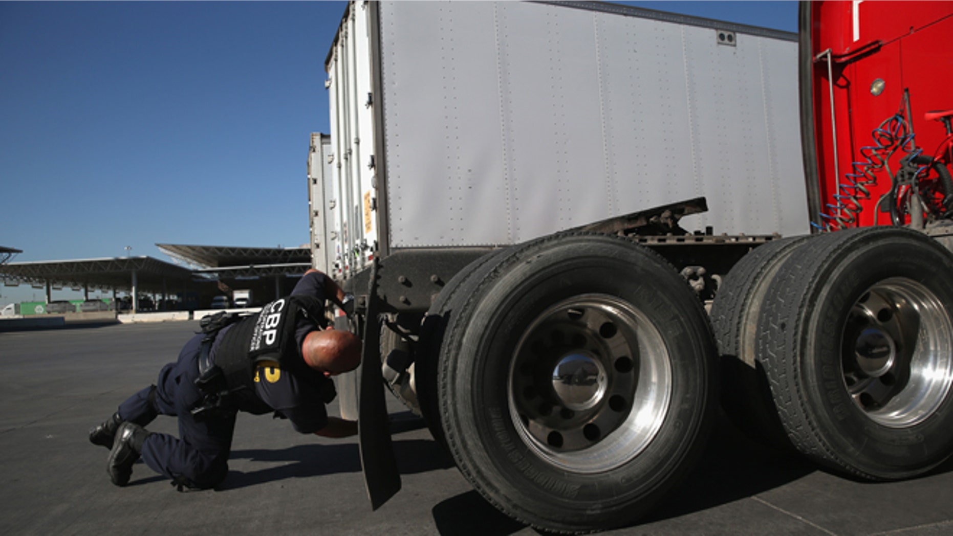 SAN DIEGO, CA - NOVEMBER 14: A U.S. Customs and Border Protection inspects a truck coming from Mexico into the United States at the Otay Mesa port of entry on November 14, 2013 in San Diego, California. Otay Mesa is the second busiest cargo port in the southwestern United States, with some 750,000 trucks passing through annually. (Photo by John Moore/Getty Images)