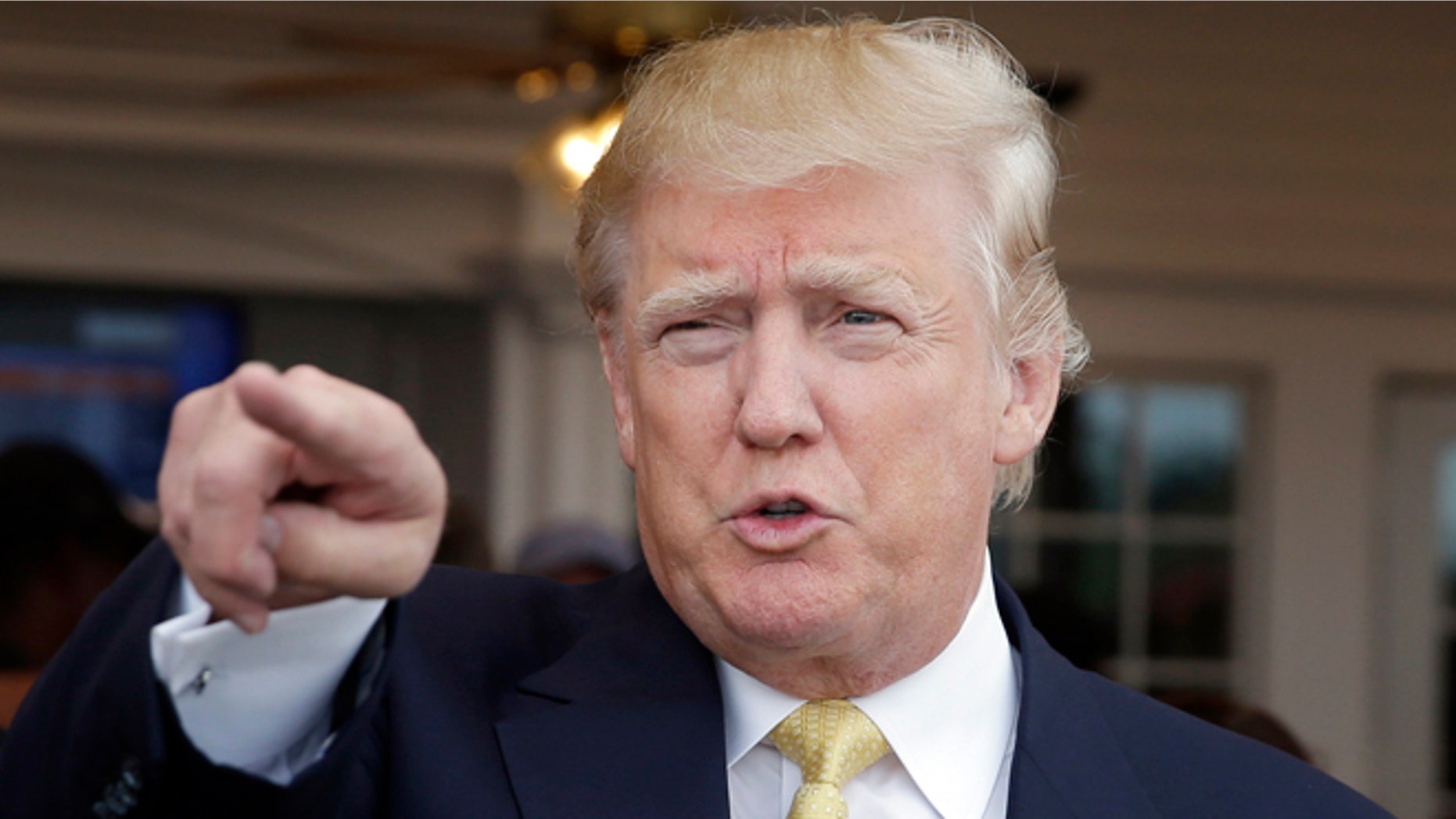 FILE - In this July 6, 2015, file photo, Republican presidential candidate Donald Trump arrives to a fundraising event at a golf course in the Bronx borough of New York. Trump is drawing larger crowds as he continues to criticize immigration policies in stark language that has revealed a deep divide between immigration hawks and moderates who are trying to avoid alienating Hispanic voters. (AP Photo/Seth Wenig, File)