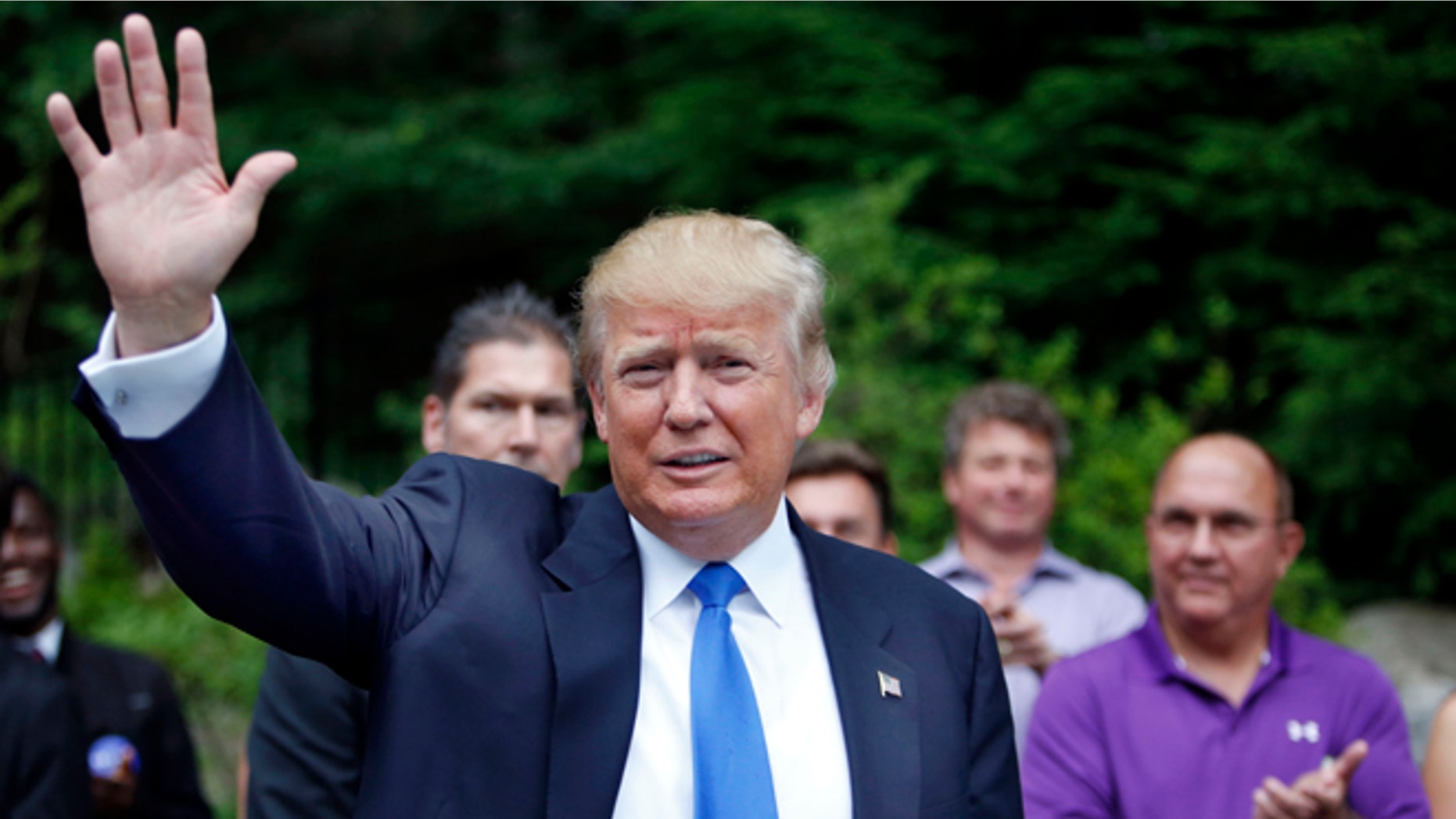 FILE - In this Tuesday, June 30, 2015 file photo, Republican presidential candidate Donald Trump waves as he arrives at a house party in Bedford, N.H. Alex Nogales, president of the National Hispanic Media Coalition, said Thursday, July 9, 2015, that more organizations need to follow the example of NBC and cut business ties with Trump. (AP Photo/Jim Cole, File)