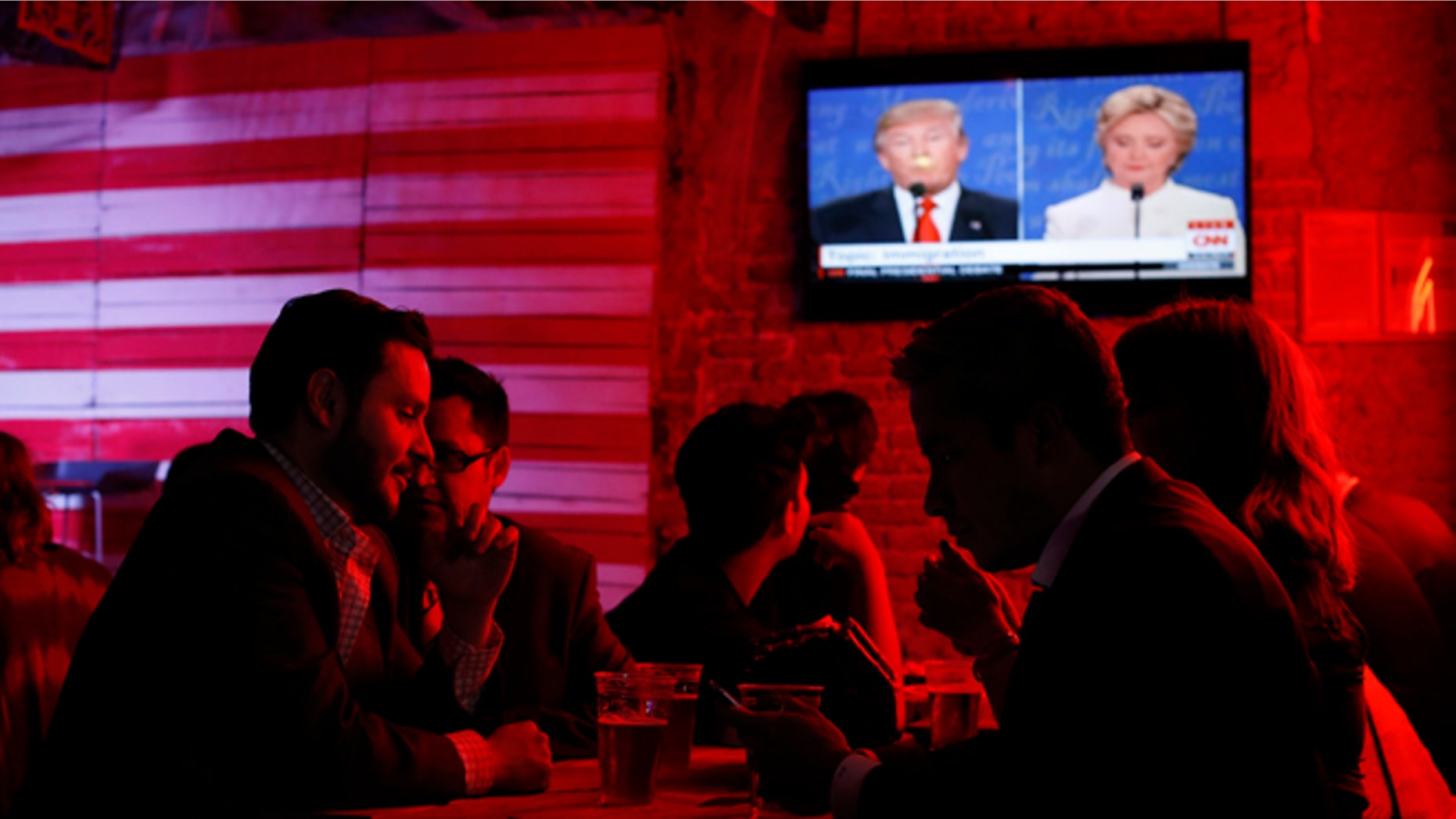Customers watch the presidential debate at the Pinche Gringo BBQ restaurant in Mexico City, on Oct. 19, 2016.