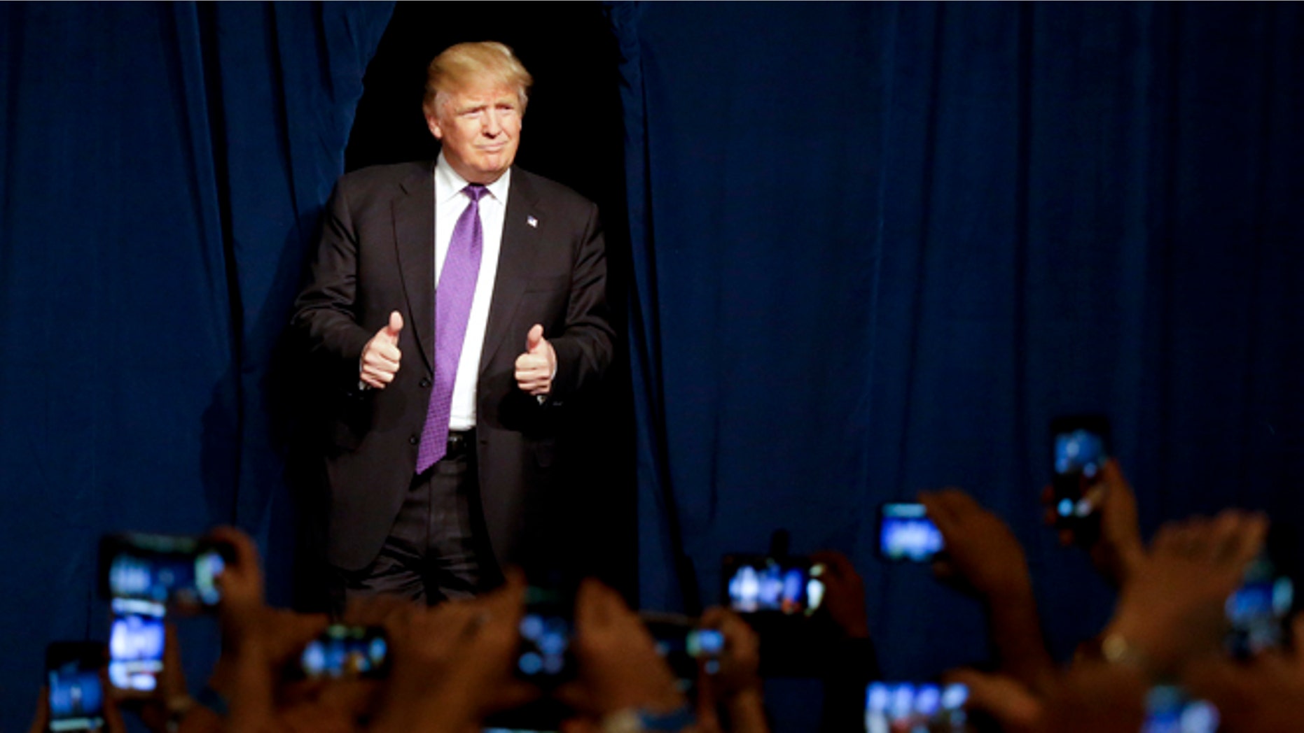Donald Trump arrives for a caucus night rally Tuesday, Feb. 23, 2016, in Las Vegas.