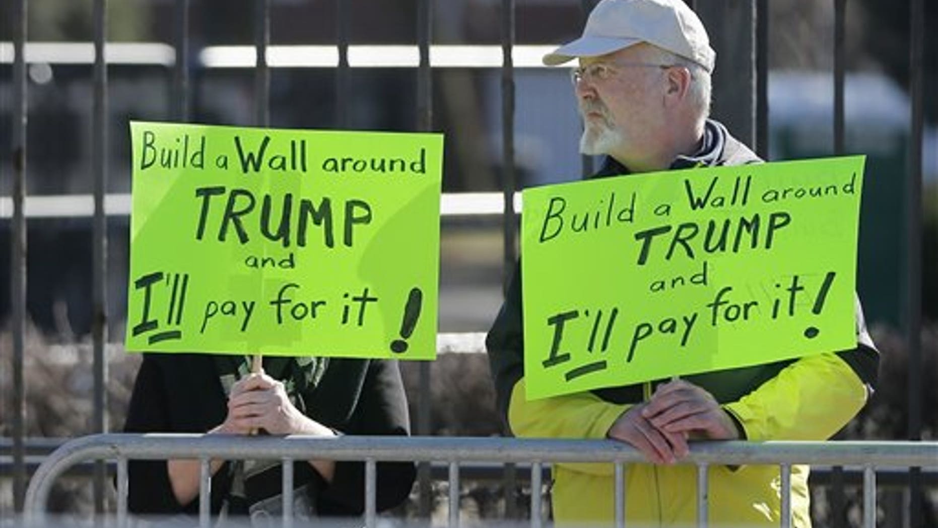 Two protesters of Republican presidential candidate, Donald Trump stand outside on the University of Illinois-Chicago campus before a Trump rally,, Friday, March 11, 2016, in Chicago. (AP Photo/Charles Rex Arbogast)