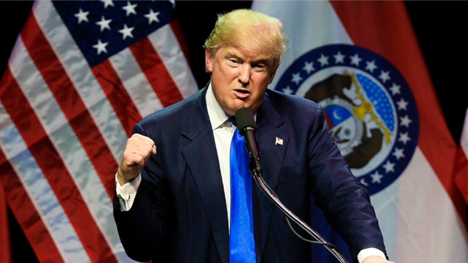 Republican presidential candidate Donald Trump describes how he was ready to punch a person who rushed the stage during an election rally earlier in the day, as he speaks to a crowd in Kansas City, Mo., Saturday, March 12, 2016. (AP Photo/Nati Harnik)