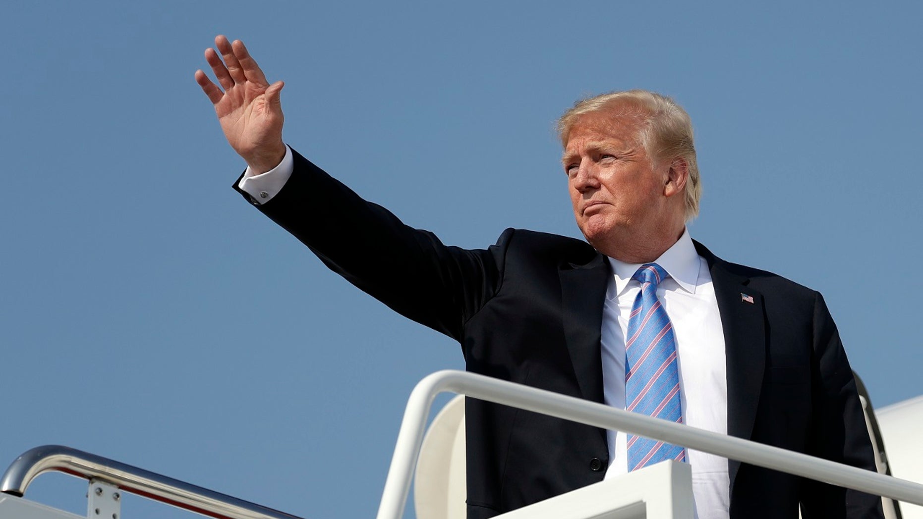 JULY 3: resident Donald Trump waves as he boards Air Force One at Andrews Air Force Base,