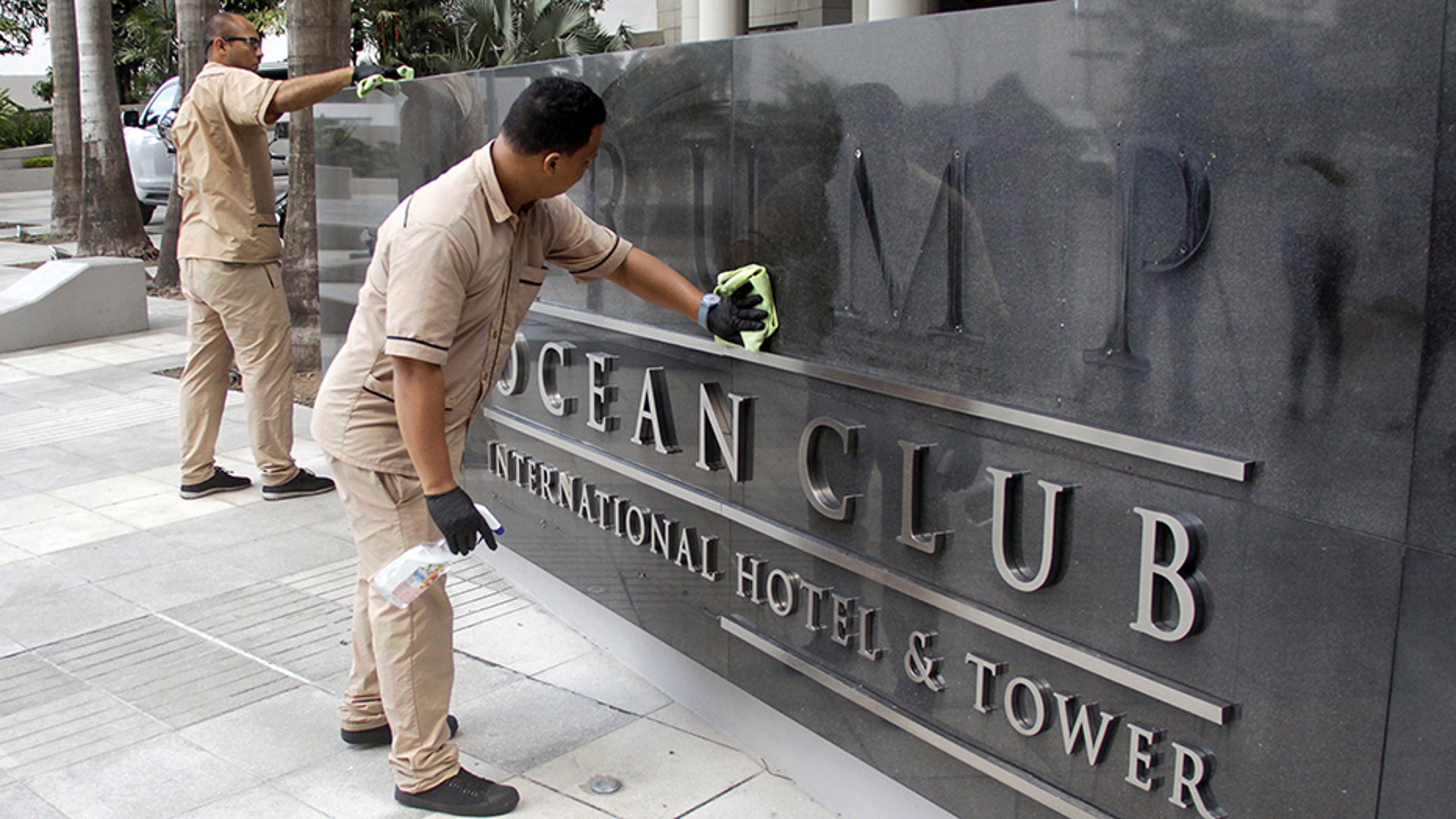 A worker cleans the site where the Trump name was removed from the Trump Ocean Club International Hotel and Tower in Panama City, Panama March 5, 2018.