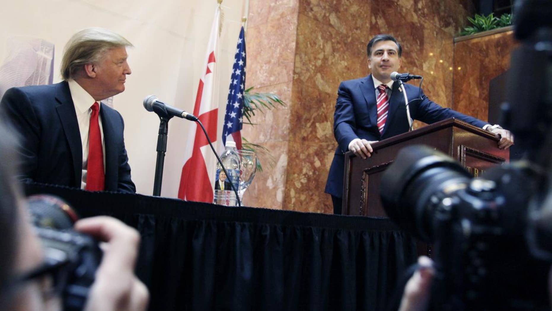 Real estate developer Donald Trump, left, listens to Mikhail Saakashvili, President of Georgia, at a news conference in New York, Thursday, March 10, 2011. Trump and a Georgian development group have agreed to build a Trump Tower in Georgia. Trump indicated he is seriously considering a run for the U.S. presidency. (AP Photo/Mark Lennihan)