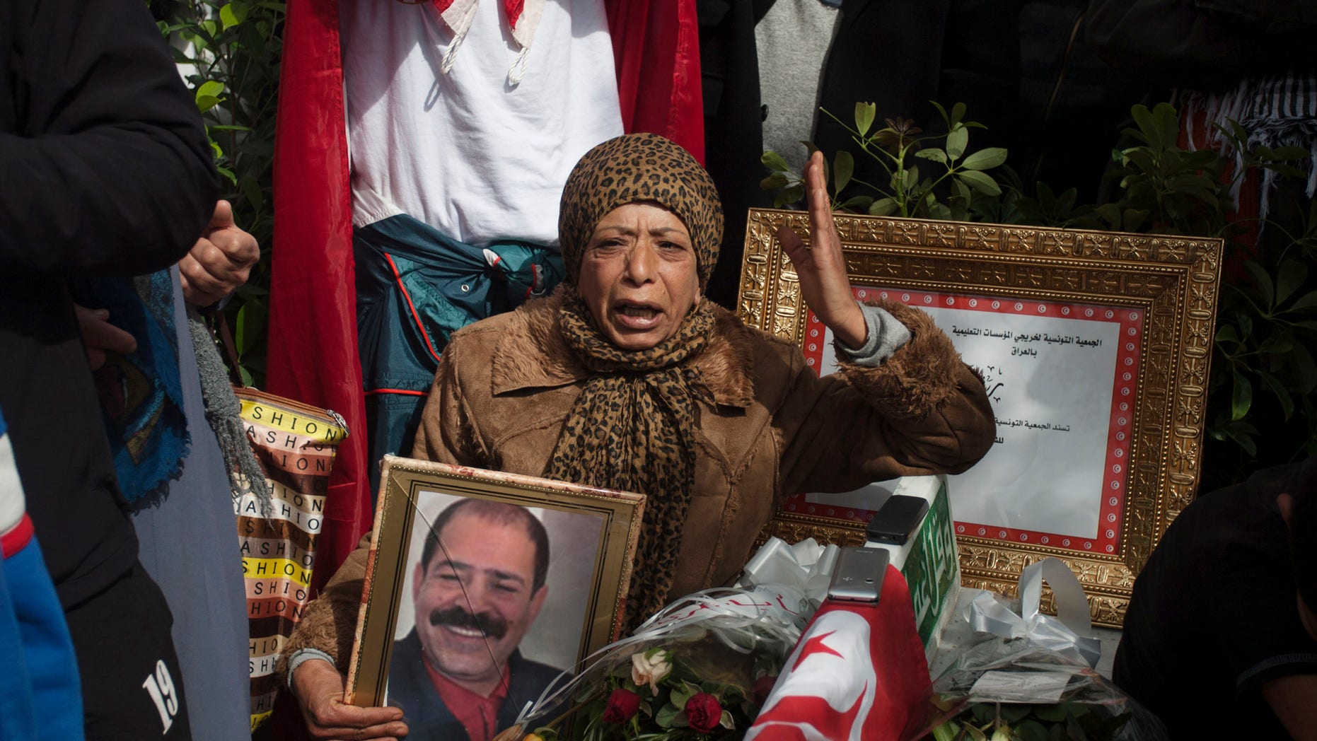 A protestor holds a portrait of slain Tunisian opposition leader Chokri Belaid, during a demonstration to mark 40 days since his death, in Tunis, Saturday, March 16, 2013. (AP Photo/Amine Landoulsi)