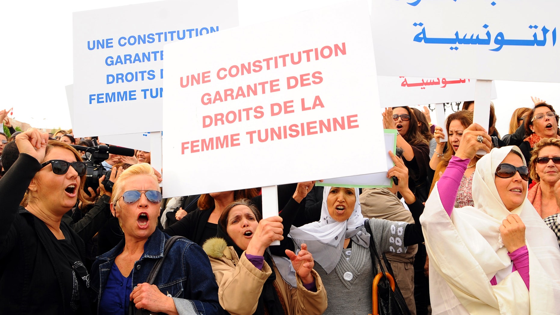 November 2: Tunisian women demonstrate for their rights during a protest in Tunis. Placards read in French: A constitution guaranteeing the rights of the Tunisian women.