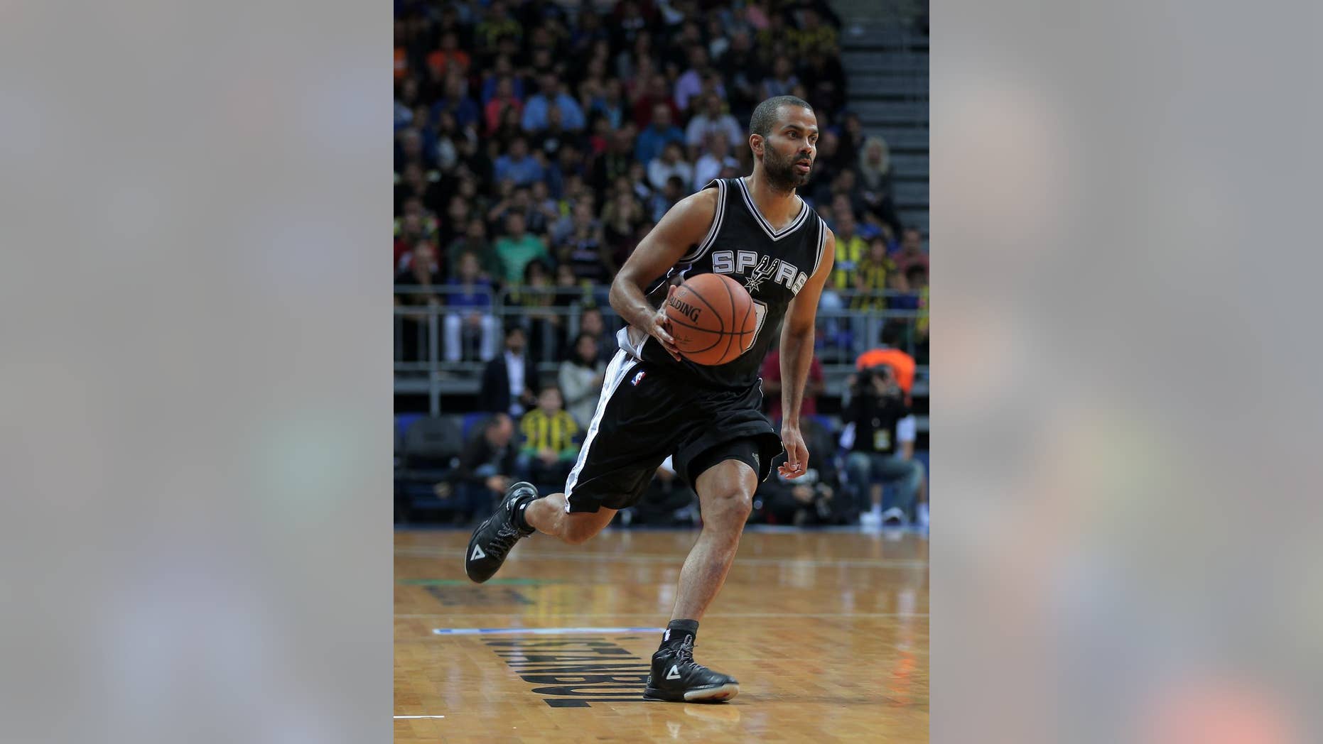 San Antonio Spurs' Tony Parker from France controls the ball during an NBA Global Games basketball match between San Antonio Spurs and Turkey's Fenerbahce Ulker, in Istanbul, Turkey, Saturday, Oct. 11, 2014. (AP Photo)