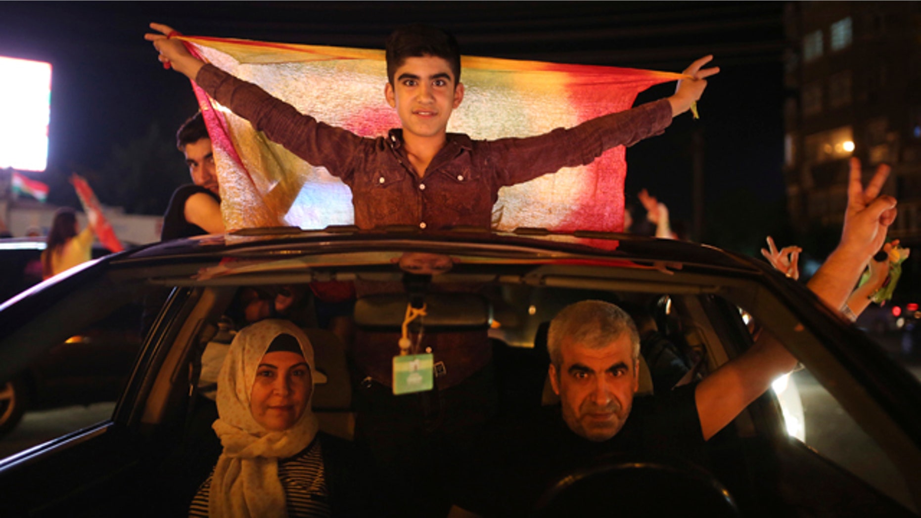 June 7, 2015: Supporters of the pro-Kurdish Peoples' Democratic Party (HDP) celebrate in Diyarbakir, southeastern Turkey. In a stunning rebuke of President Recep Tayyip Erdogan's ambitions to expand his powers, Turkish voters stripped his party of its simple majority in parliament, preliminary election results showed Sunday. (AP Photo/Emrah Tazegul)