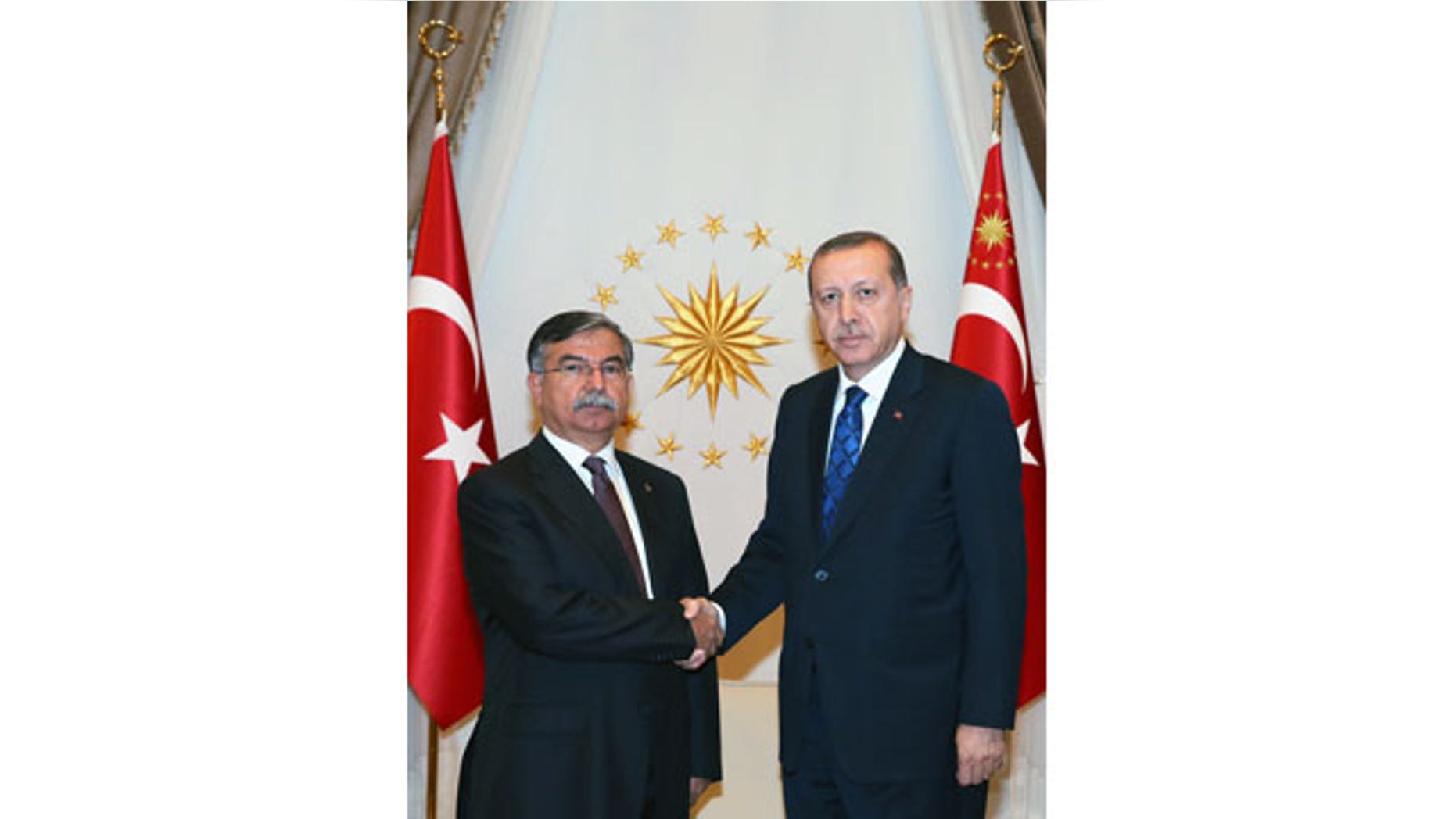 Aug. 24, 2015: Turkey's President Recep Tayyip Erdogan, right, shakes hands with Parliament Speaker Ismet Yilmaz in Ankara. (AP Photo/Presidential Press Service, Pool)