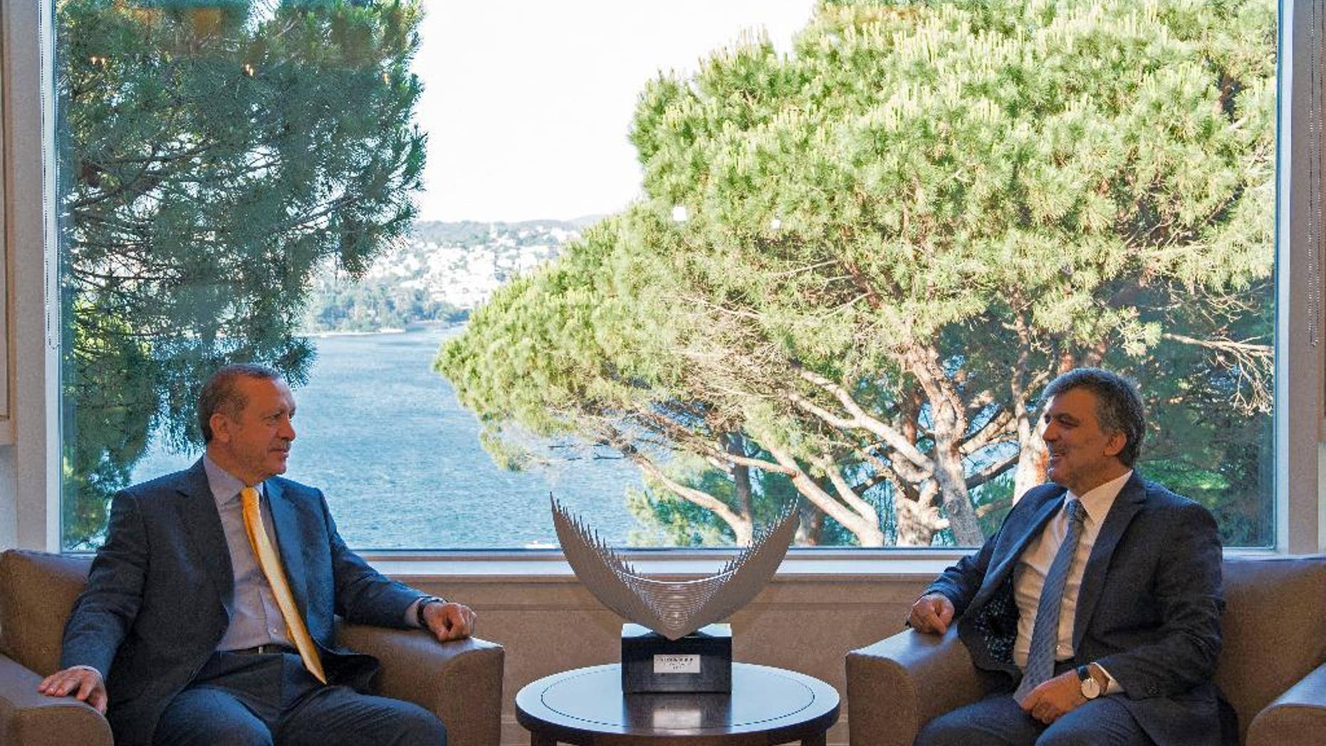 In this photo released by the Turkish Presidency Press Office, Turkish President Abdullah Gul, right, and Prime Minister Recep Tayyip Erdogan speak during a meeting in Istanbul, Turkey, Sunday, June 29, 2014. Turkey's ruling Justice and Development Party is expected to announce Erdogan as their candidate to run in presidential elections in August against senior Turkish diplomat professor Ekmeleddin Mehmet Ihsanoglu, the former Secretary-General of the Organisation of Islamic Cooperation. (AP Photo/Ayhan Arfat, Turkish Presidency Press Office, HO)