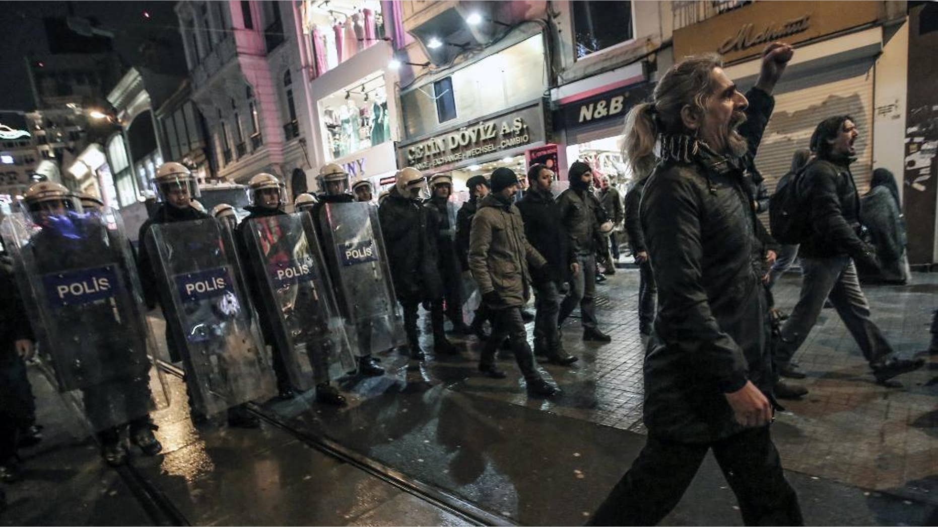 People protest the death of Berkin Elvan, a Turkish teenager who was in a coma since being hit in the head by a tear gas canister fired by police during the summer's anti-government protests, in Istanbul, Turkey, Tuesday, March 11, 2014. The 15-year old Berkin Elvan’s death in an Istanbul hospital _ nine months after he fell into a coma _ looked likely to spark new protests in Turkey. Riot police fired tear gas, water cannon and rubber bullets to disperse anti-government protesters trying to converge in central Ankara and Istanbul hours after Berkin Elvan’s family announced his death.(AP Photo/Emrah Gurel)