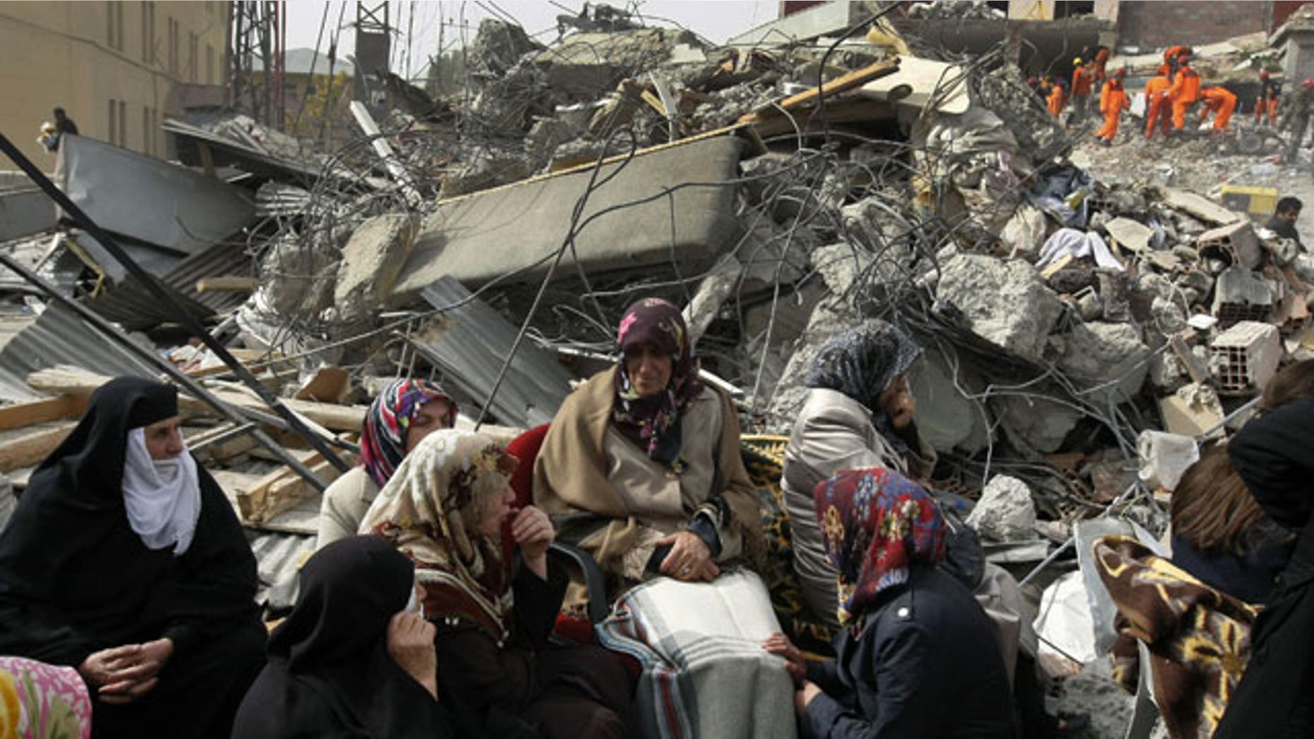 October 25, 2011: Family members wait for news as Turkish and Azeri rescuers work to save people trapped under the rubble of a collapsed building in Ercis, eastern Turkey.