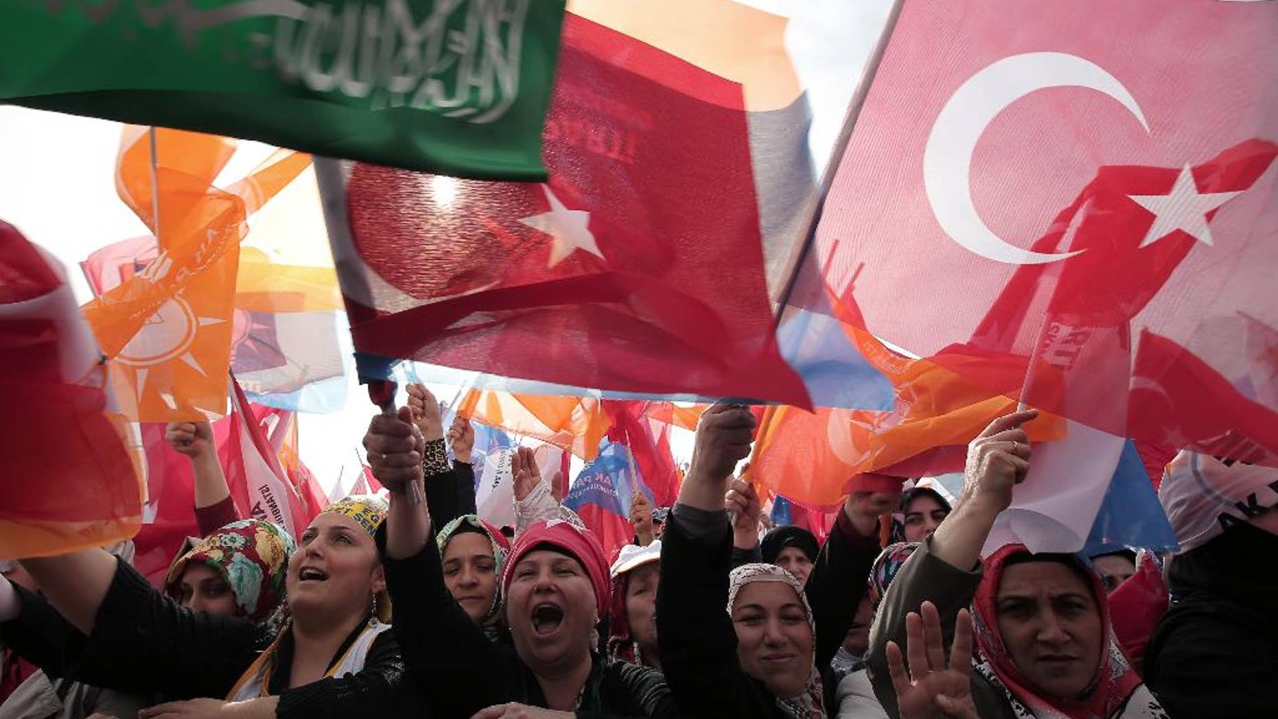 The supporters listen to Turkish Prime Minister Recep Tayyip Erdogan who addressed a rally of his Justice and Development Party in Istanbul, Turkey, Sunday, March 23, 2014. Turkish fighter jets shot down a Syrian warplane after it violated Turkey's airspace Sunday, Erdogan said, in a move likely to ramp up tensions between the two countries already deeply at odds over Syria's civil war. Erdogan is fighting corruption allegations against his government a week before local elections that are seen as a referendum over his rule. (AP Photo/Emrah Gurel)