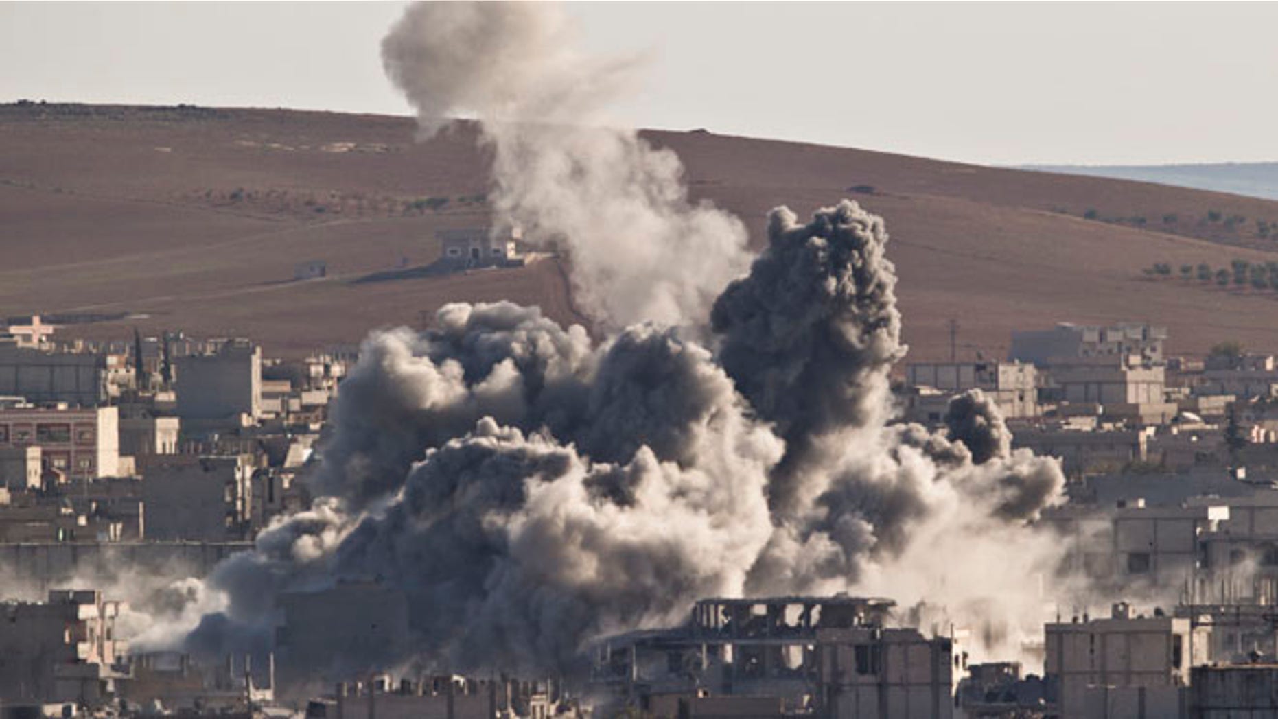 Nov. 9, 2014: Smoke rises in the Syrian town of Kobani, after an airstrike by the US led coalition, seen from a hilltop outside Suruc, on the Turkey-Syria border. (AP)