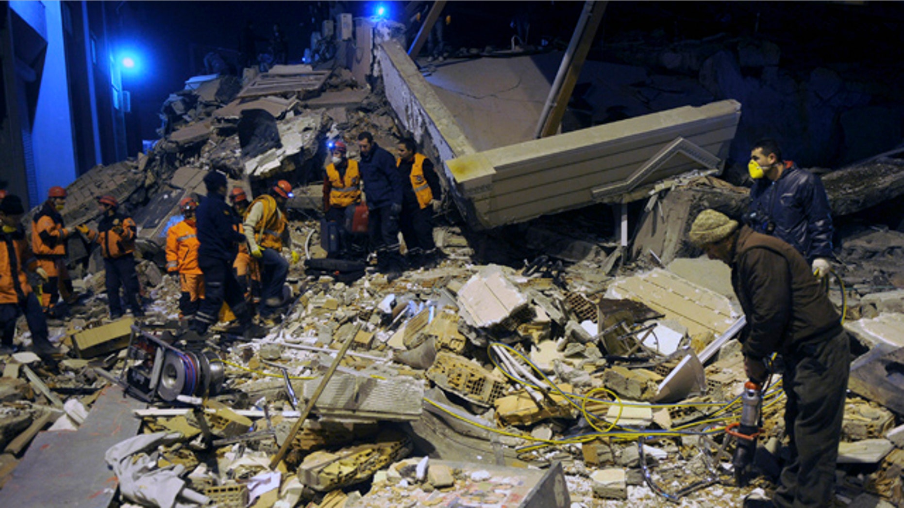 Nov. 9: Rescuers search for survivors in the rubble of a collapsed hotel in Van, eastern Turkey.