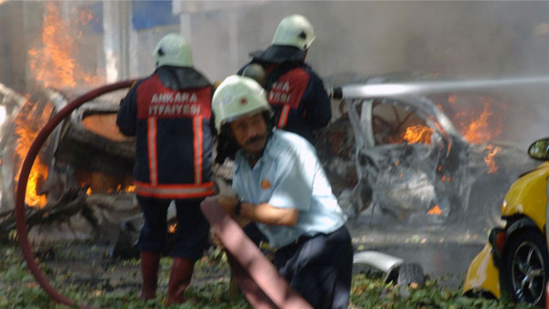 Firefighters are seen working at the site after a suspected car bomb exploded in a busy street in the Turkish capital Ankara, Turkey, Tuesday, Sept. 20, 2011.