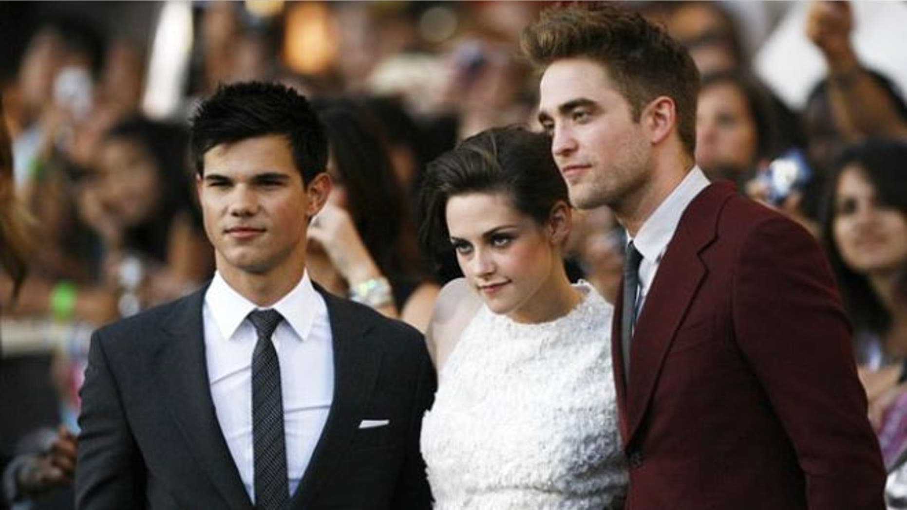 FILE: 'Twilight' stars Taylor Lautner, Kristen Stewart and Robert Pattinson pose for cameras at the premiere of the film.