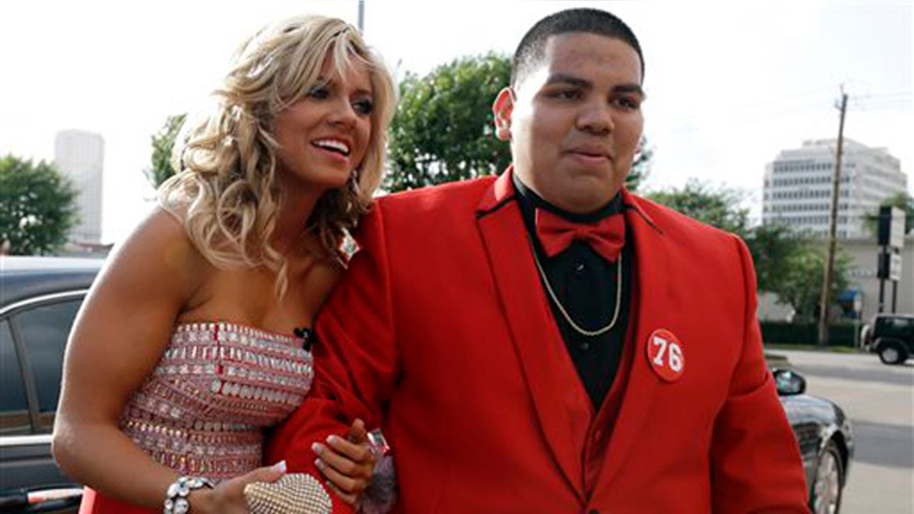 High school student Michael Ramirez, right, and Houston Texans cheerleader Caitlyn pose for pictures outside a restaurant before attending the prom Saturday, May 10, 2014, in Houston. Ramirez sent Caitlyn a Twitter message saying âIf I get 10,000 retweets will you go to prom with me (insert smiley face.) you will get asked in a cute way!â He did and so she said yes. (AP Photo/Pat Sullivan)