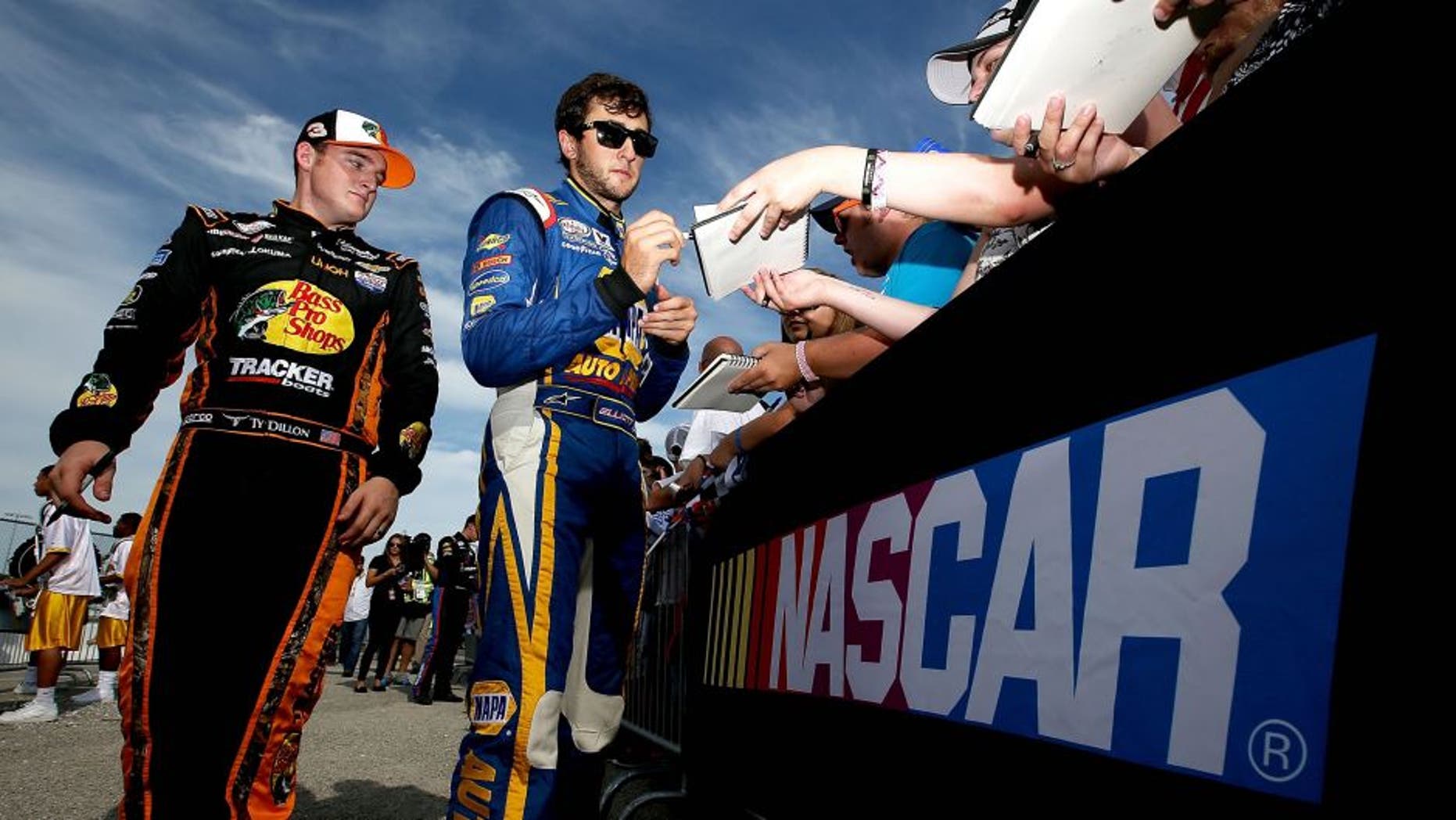 NEWTON, IA - AUGUST 01: Chase Elliott, driver of the #9 NAPA Auto Parts Chevrolet, and Ty Dillon, driver of the #3 Bass Pro Shops/Tracker Boats Chevrolet, sign autographs prior to the start of the NASCAR XFINITY Series U.S. Cellular 250 at Iowa Speedway on August 1, 2015 in Newton, Iowa. (Photo by Sean Gardner/NASCAR via Getty Images)
