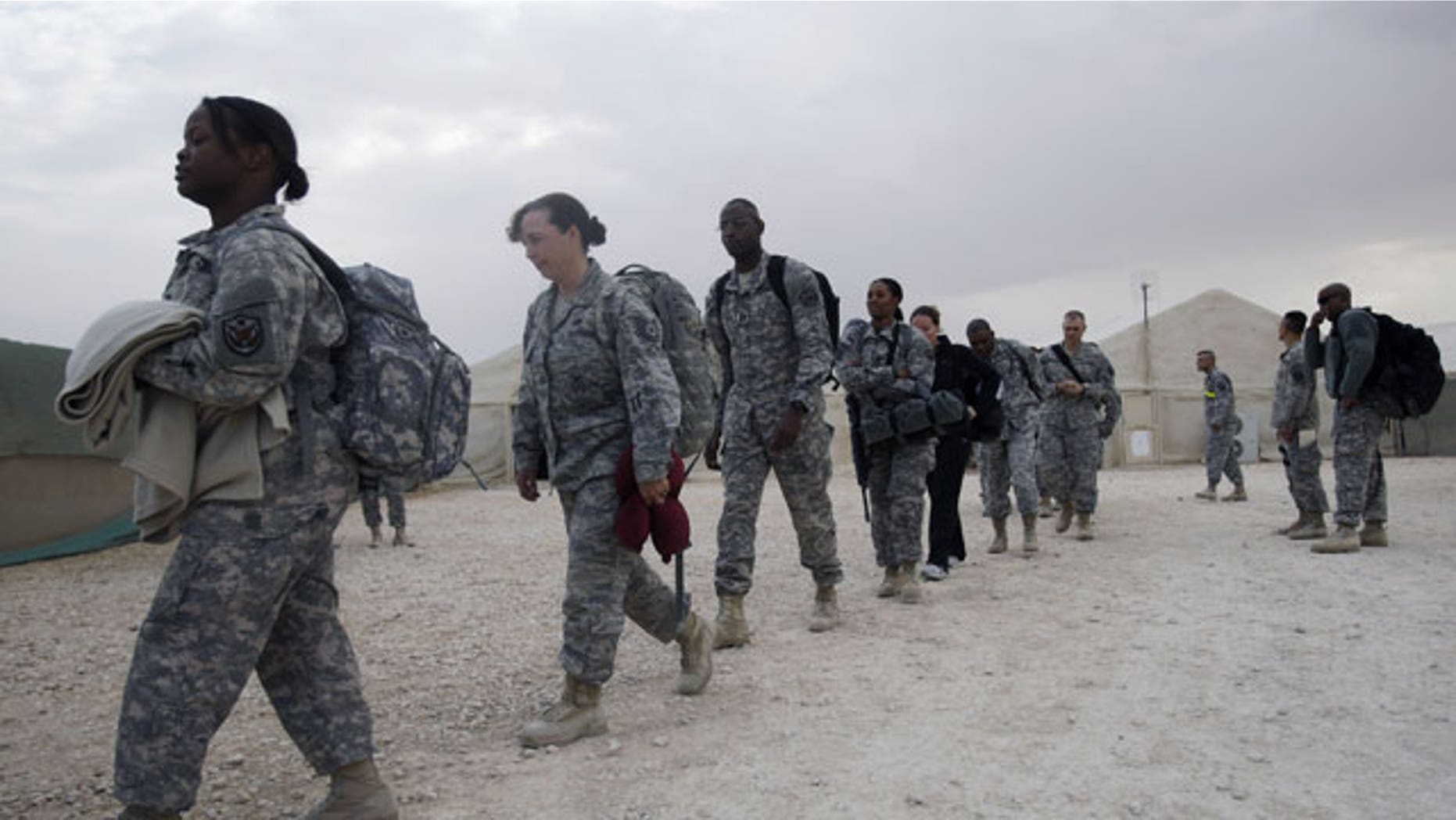 November 1, 2011: U.S. troops queue to board a bus as they begin their journey home at al-Asad Air Base west of Baghdad, Iraq.