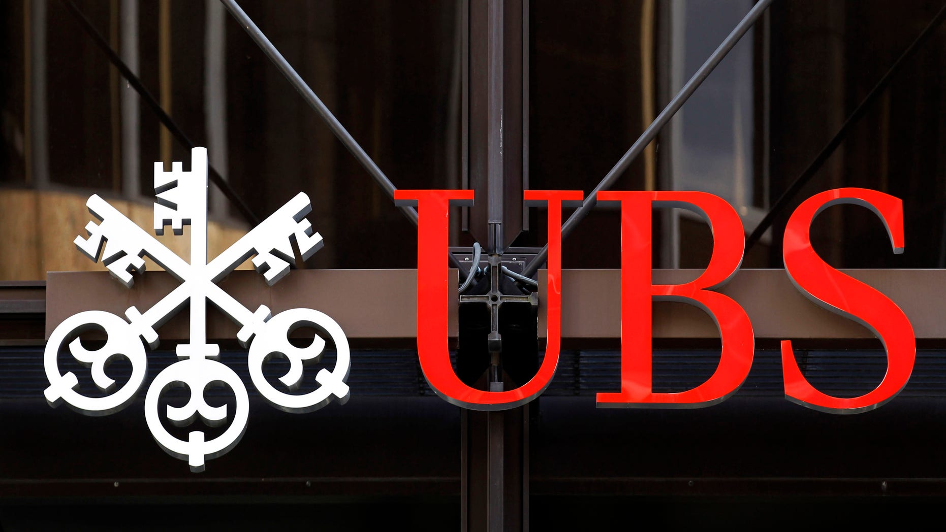 A logo for Swiss bank UBS is seen outside one of their offices in the City of London, Thursday, Sept. 15, 2011. Swiss banking giant UBS said Thursday that a rogue trader has caused it an estimated loss of $2 billion, stunning a beleaguered banking industry that has proven vulnerable to unauthorized trades.