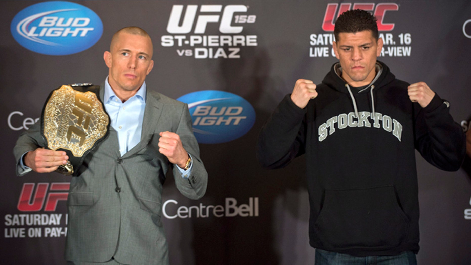 Mixed Martial Arts fighters Georges St-Pierre, left, and Nick Diaz pose for the media following their news conference in Montreal, Thursday, March 14, 2013. The pair will meet in a UFC 158 title fight in Montreal on Saturday. (AP Photo/The Canadian Press, Graham Hughes)