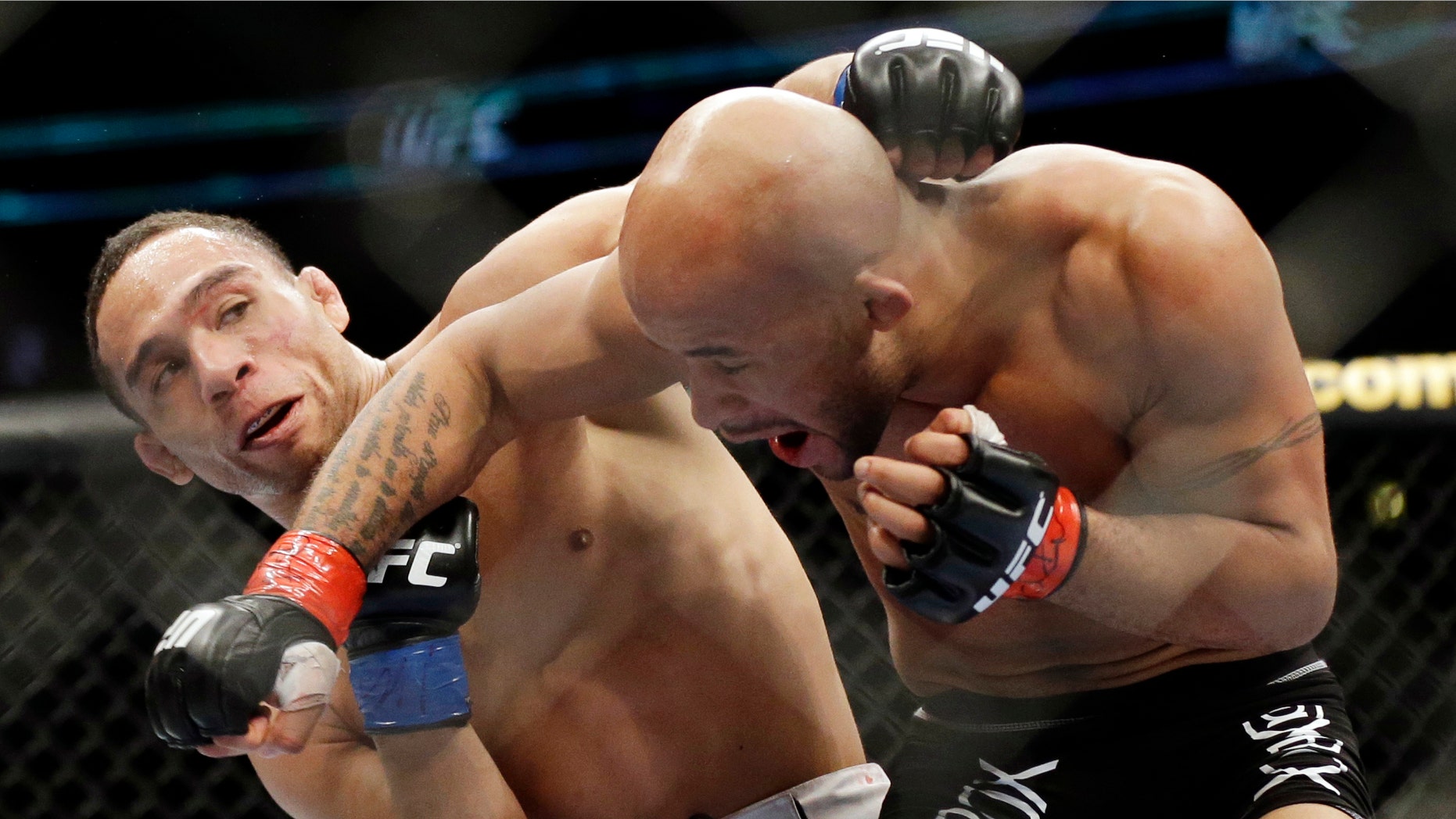 John Dodson, left, fights Demetrious Johnson during the UFC flyweight championship on FOX 6 at United Center in Chicago, Saturday, Jan. 26, 2013. (AP Photo/Nam Y. Huh)
