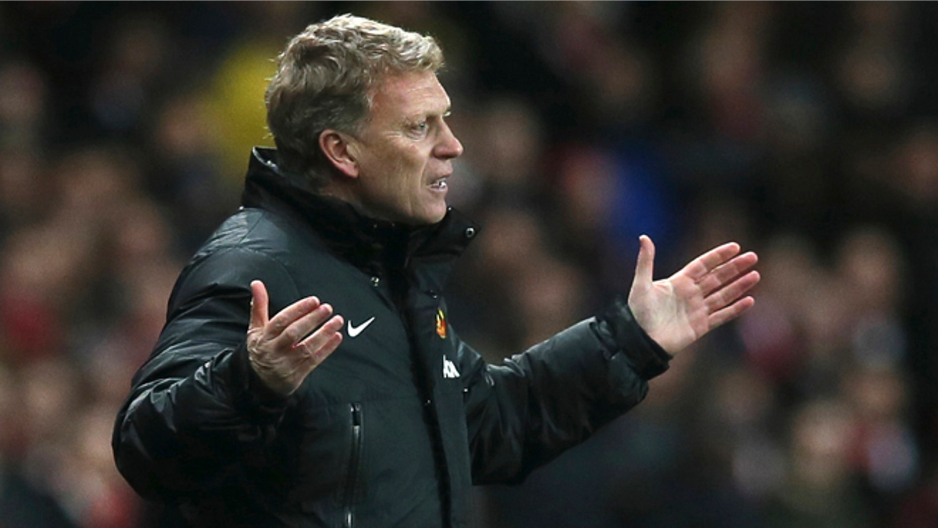 FILE - In this Wednesday, Feb. 12, 2014 file photo Manchester United's manager David Moyes gestures to his team during their English Premier League soccer match between Arsenal and Manchester United at the Emirates stadium in London. Manchester United says manager David Moyes has left the Premier League club after less than a year in charge, amid heavy speculation he was about to be fired. United released a brief statement in its website Tuesday, saying the club "would like to place on record its thanks for the hard work, honesty and integrity he brought to the role." (AP Photo/Alastair Grant, File)